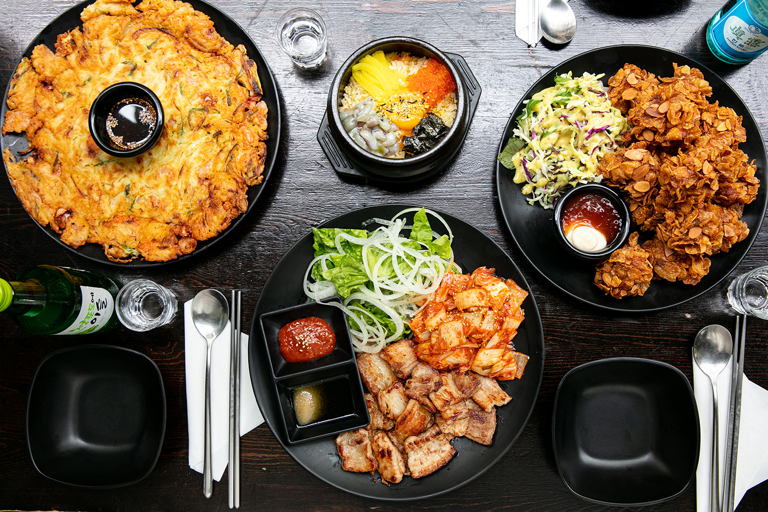The seafood pancake, fish roe and rice, almond crunch chicken and pork with roast garlic. Photo / Babiche Martens