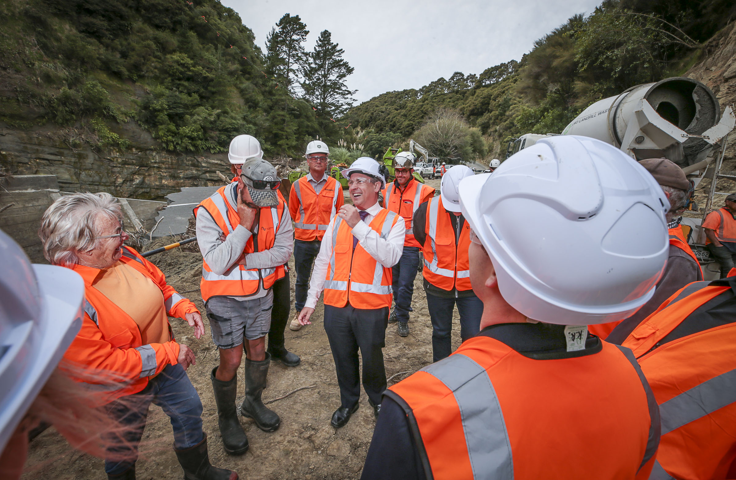 Minister of Transport Michael Wood, contractors and Waka Kotahi NZTA staff take locals around the Waikare Gorge Bailey Bridge construction site earlier this month. Photo / Paul Taylor