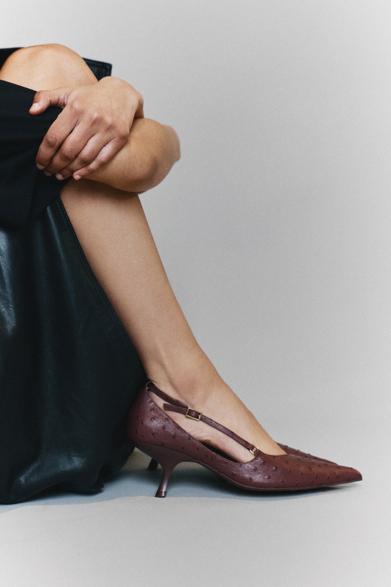 The Epona heel in radicchio red features embossed leather.