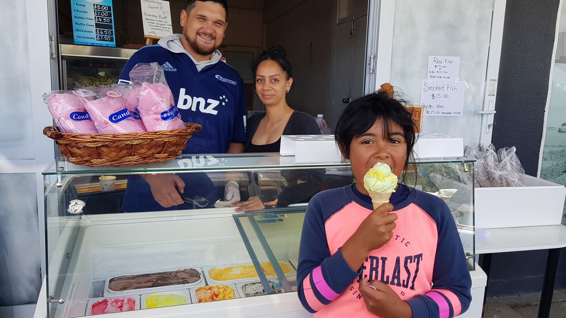 Tahlei Dunn, 9, enjoys the ice cream Robert Ngaera and Ricky-Leigh Larkins, from 90 Mile Takeaways have just served her