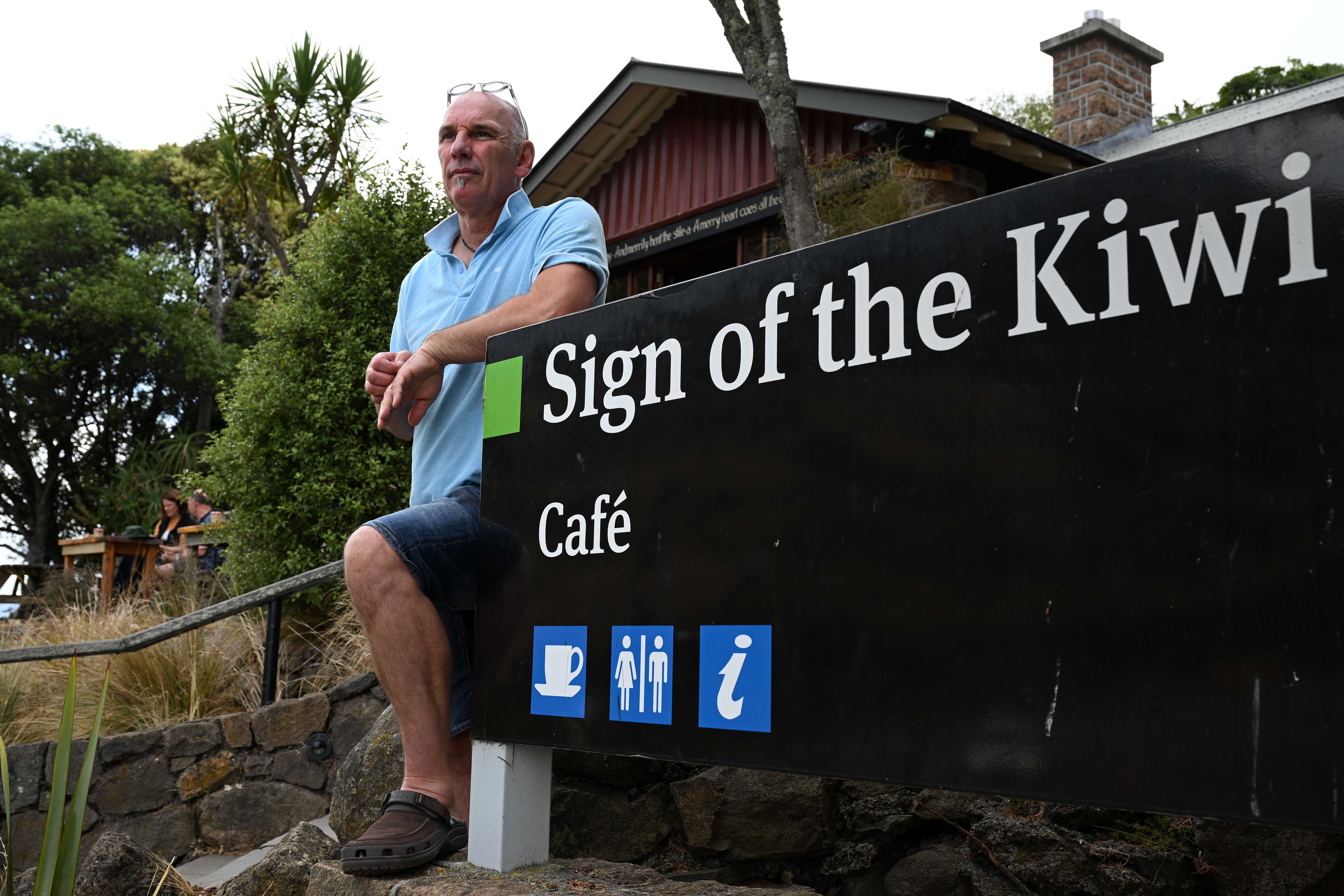 Sign of the Kiwi owner Eric Devos is shutting down his cafe until recreational tracks in the area reopen. A large fire has broken out in Chritchurch’s Port Hills causing mass evacuations. 17 February 2024 New Zealand Herald Photograph by Joe Allison
