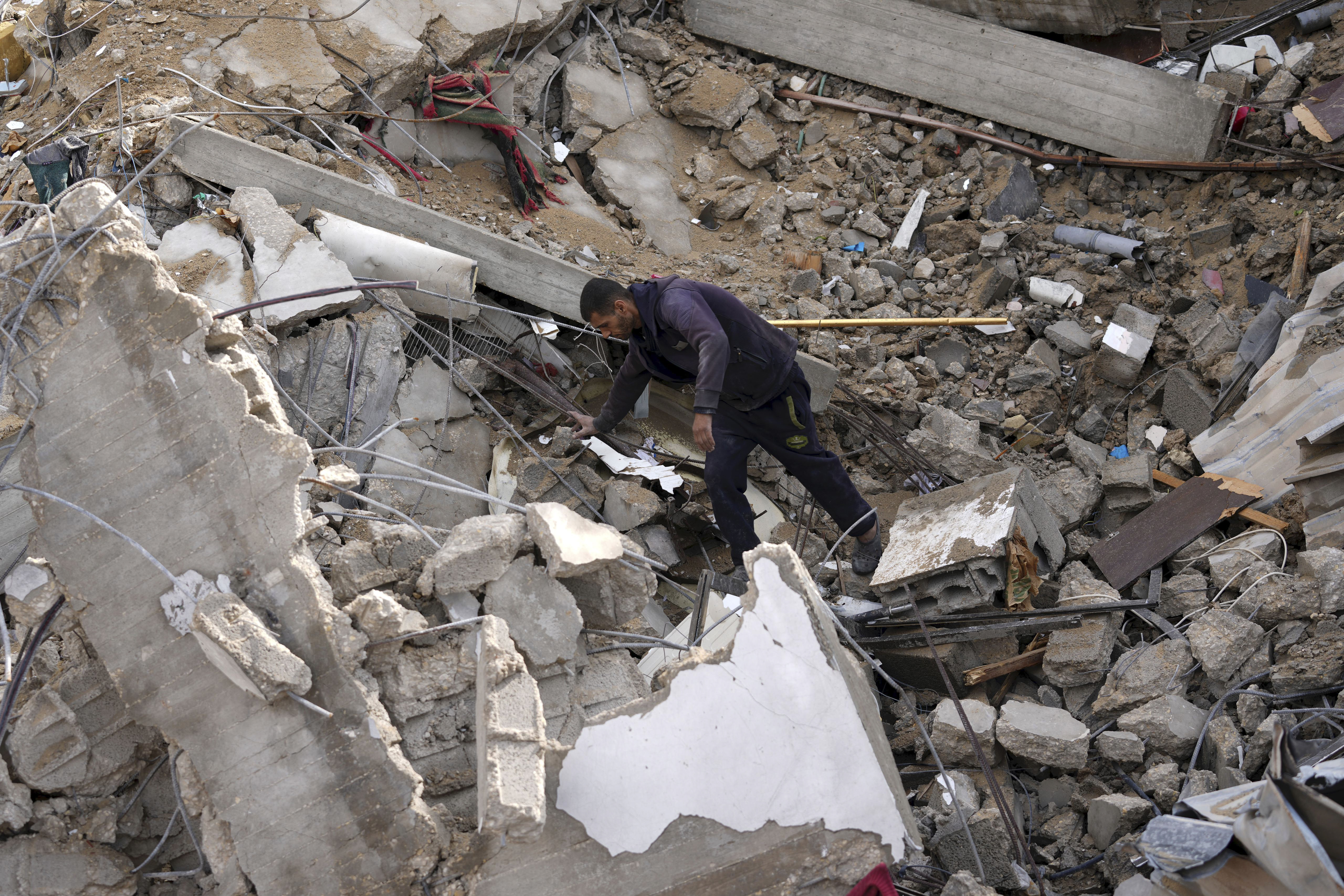 A Palestinian looks at the destruction after an Israeli strike at a residential building in Deir al Balah, Gaza Strip. Photo / AP