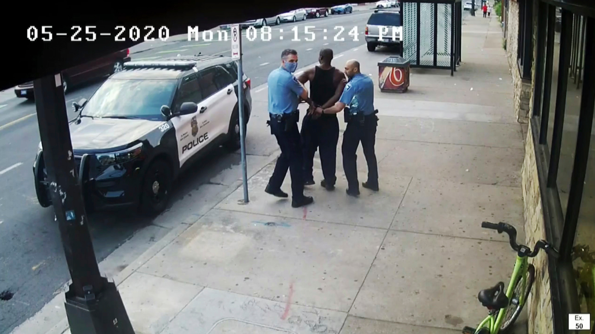 Former Minneapolis Police Officers Thomas Lane, (left) and J. Alexander Kueng escorting George Floyd to a police vehicle outside. Photo / AP