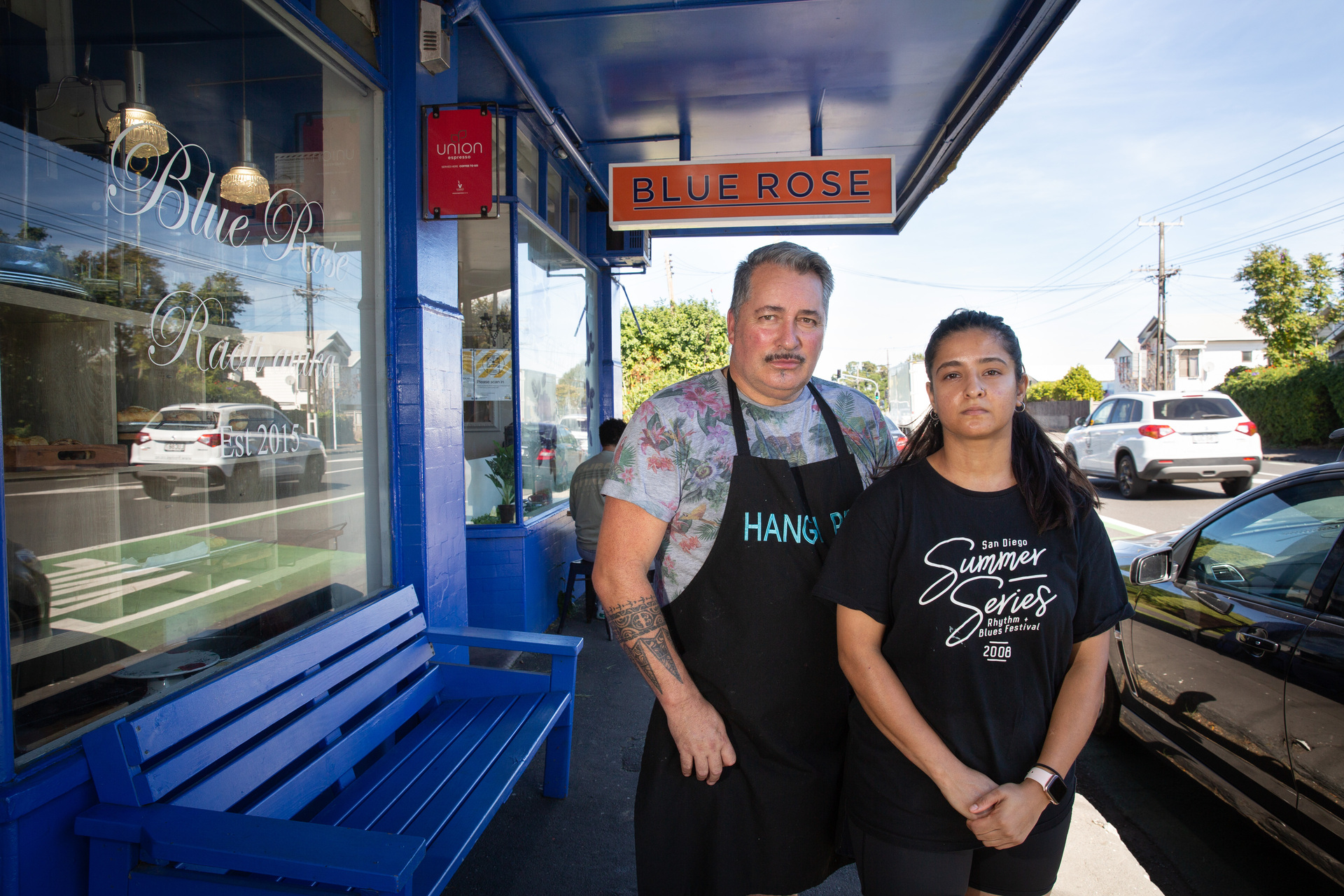 Robbie Kainuku, owner of the Blue Rose Cafe on Sandringham Rd, pictured with staff member Paridhi Bakshi. Photo / Sylvie Whinray