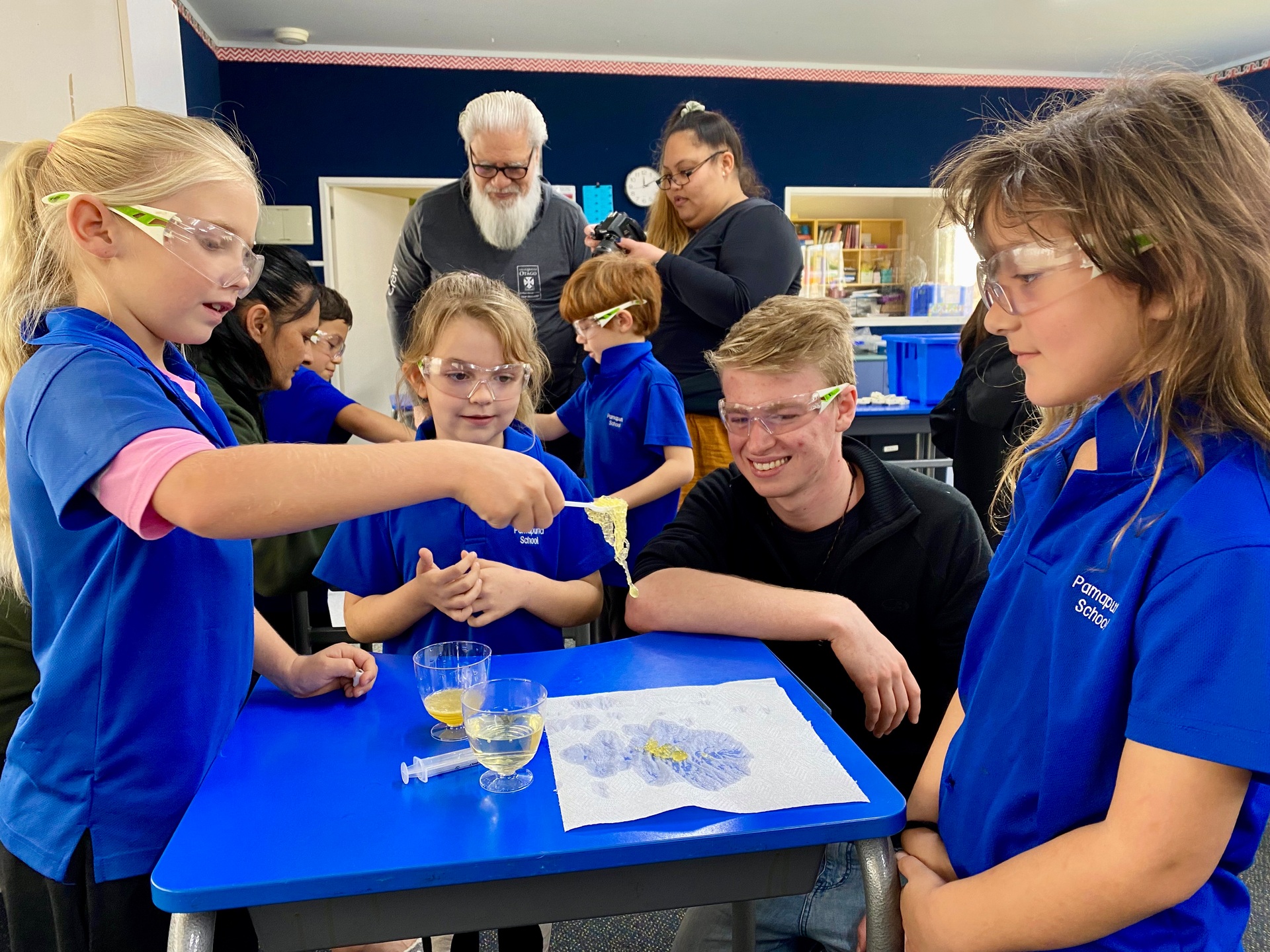 Otago University chemistry students holding a science workshop focused on plastics with Pamapuria School pupils. Photo / Supplied