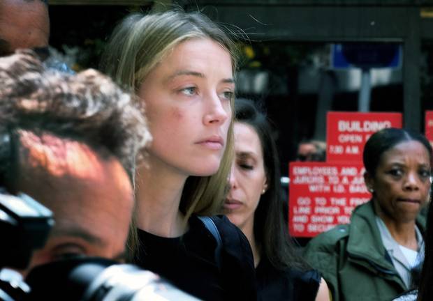 Actress Amber Heard leaves Los Angeles Superior Court court, after giving a sworn declaration that her husband Johnny Depp threw her cellphone at her during a fight. Photo / AP
