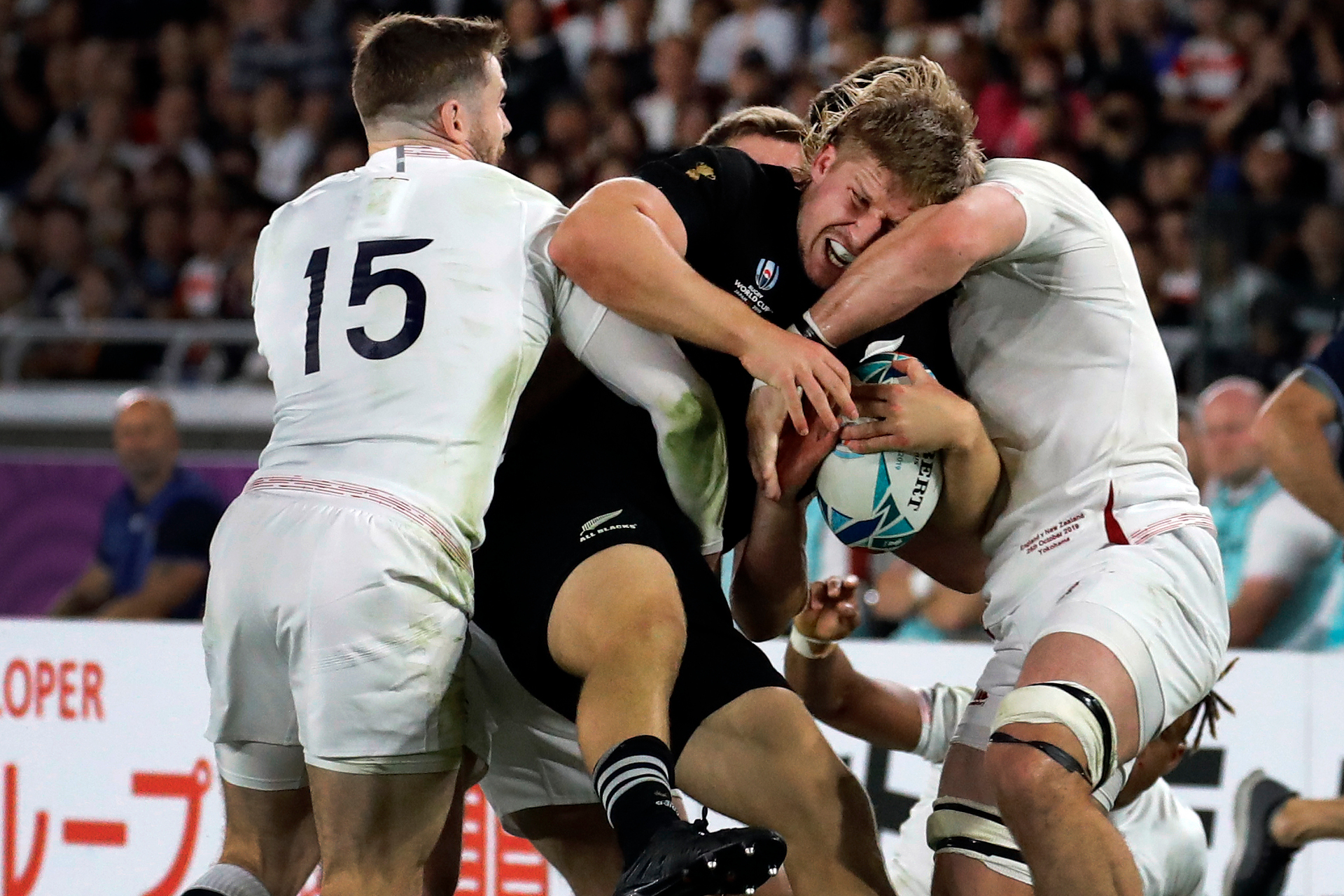 England's Elliot Daly, left, tackles New Zealand's Jack Goodhue during the Rugby World Cup semifinal at International Yokohama Stadium between New Zealand and England. Photo / AP