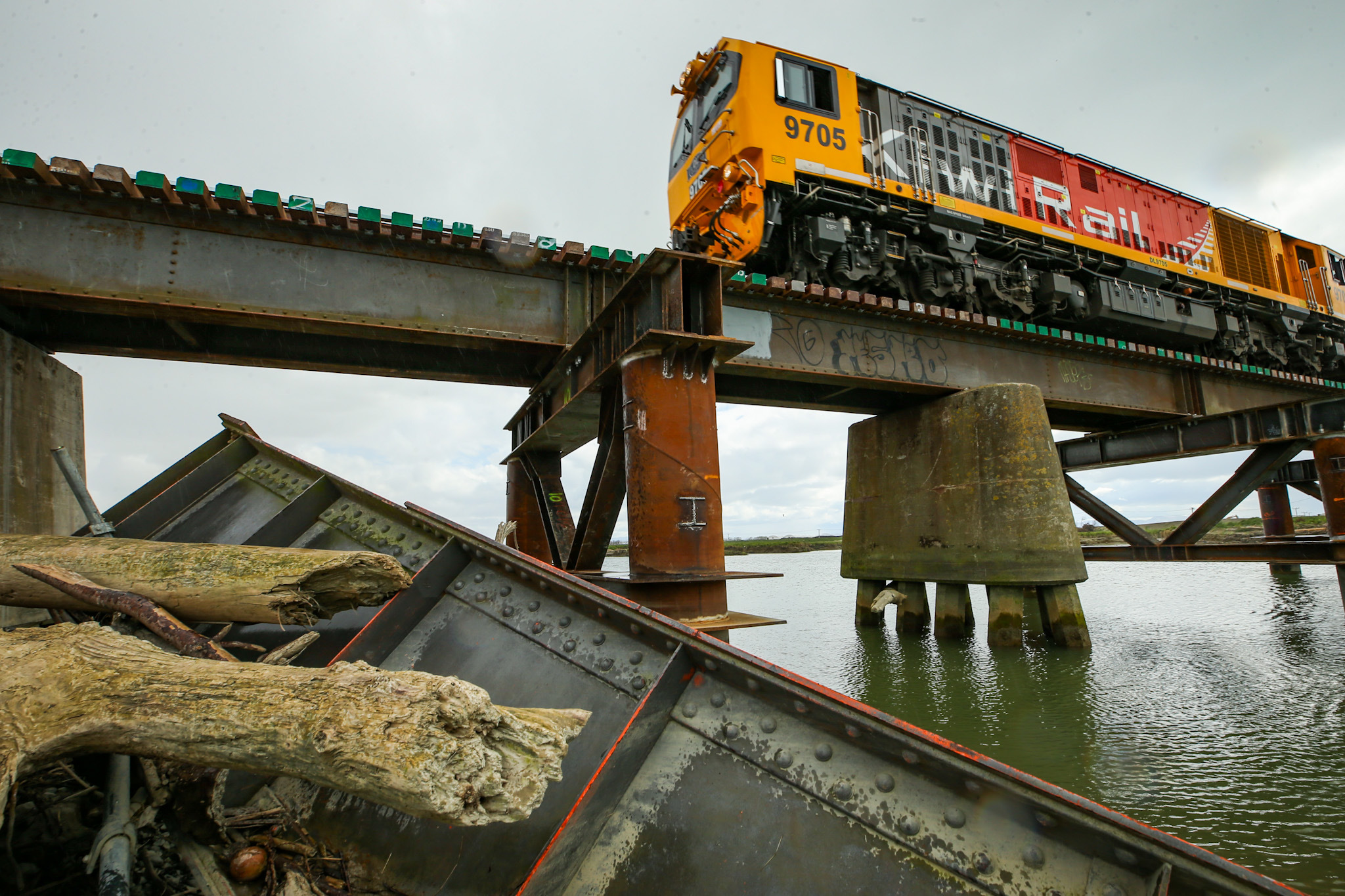 A train crosses the rebuilt Waitangi Rail Bridge just outside of Napier, during the reopening on Friday. Photo / Paul Taylor