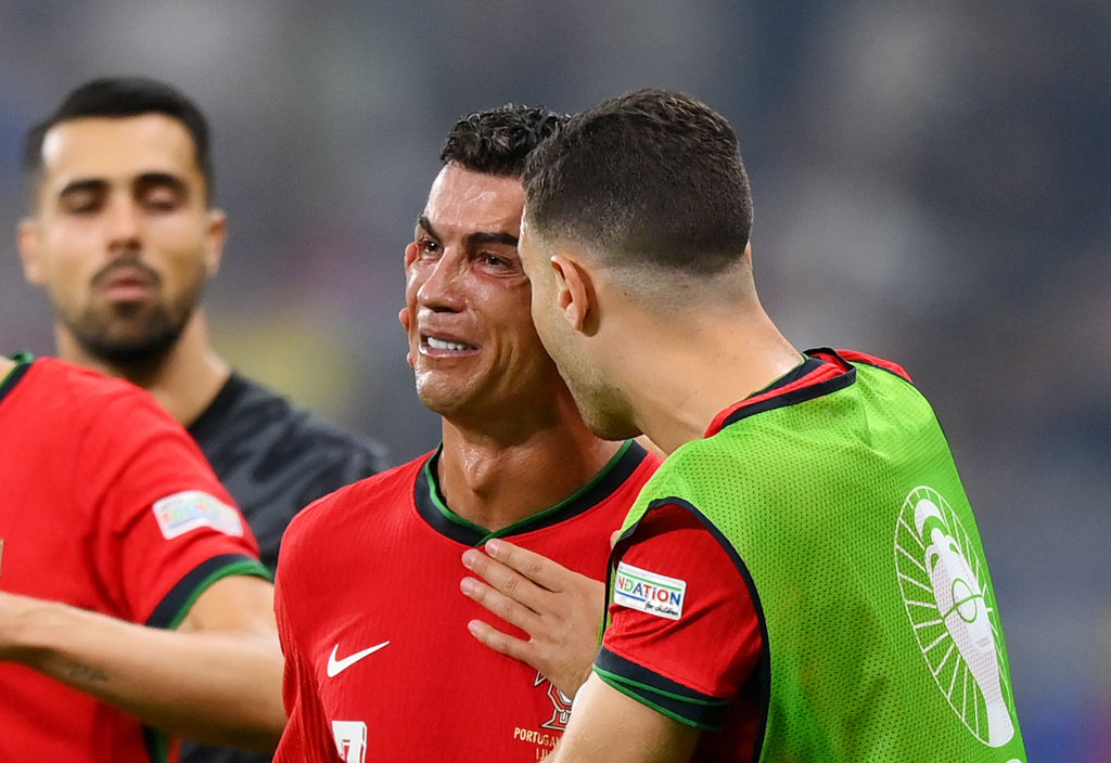 Cristiano Ronaldo of Portugal looks dejected as he is consoled by teammates ahead of the second half of extra-time against Slovenia. Photo / Getty Images