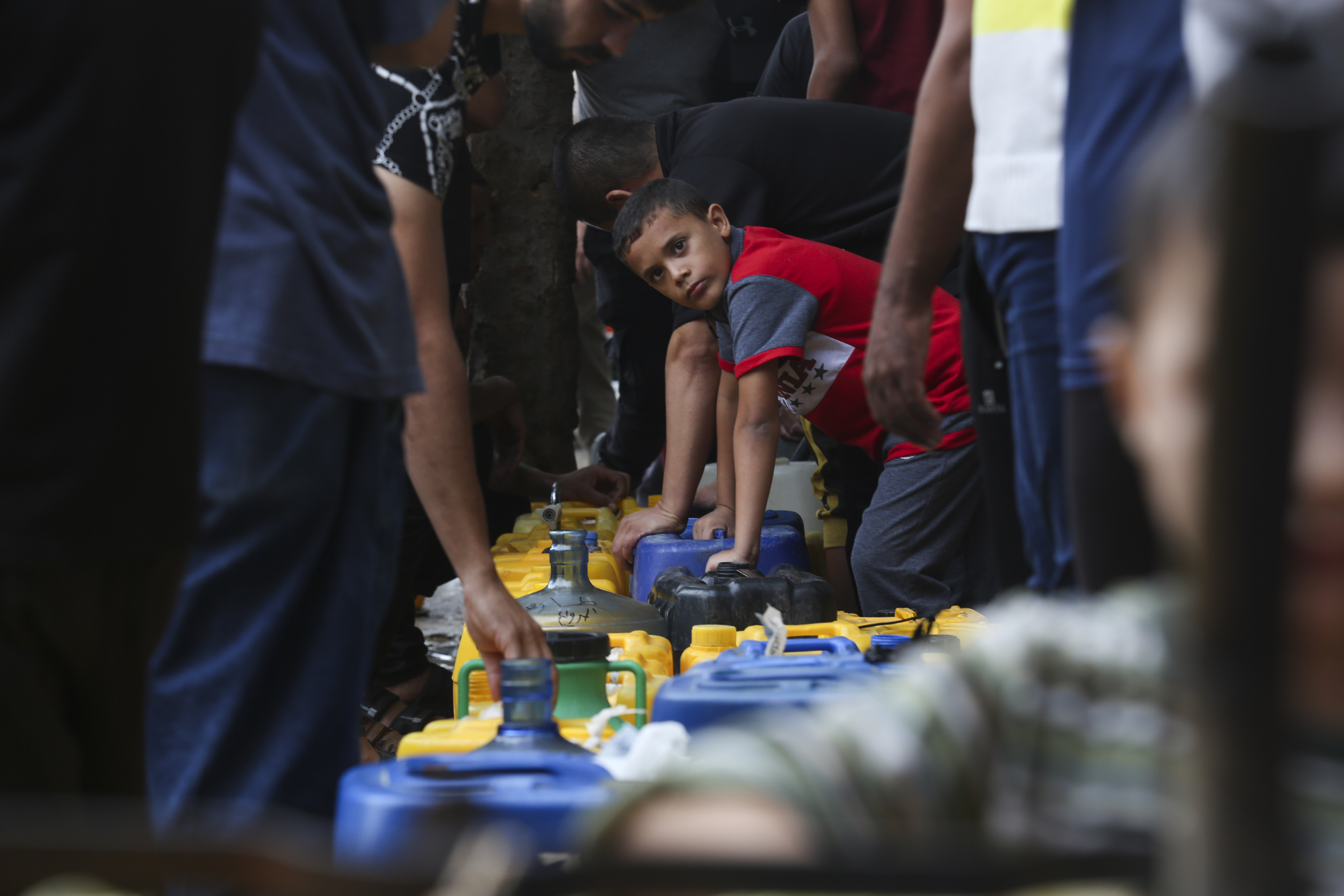 Palestinians collect drinking water in Rafah. Photo / AP