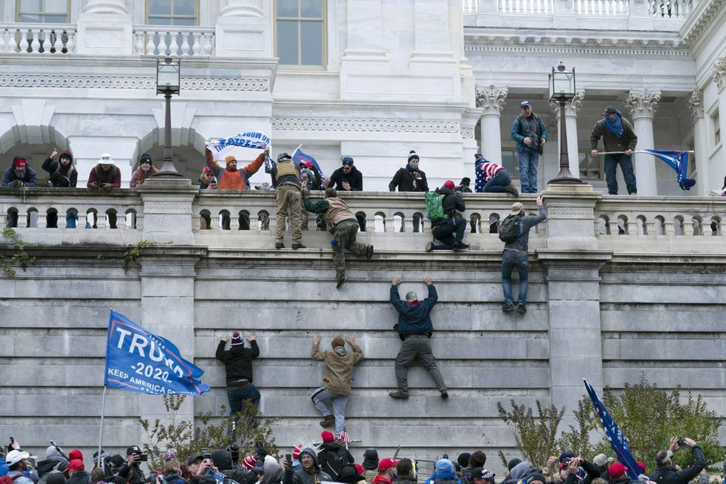 Supporters of President Donald Trump climb the west wall of the the US Capitol in Washington. Photo / AP