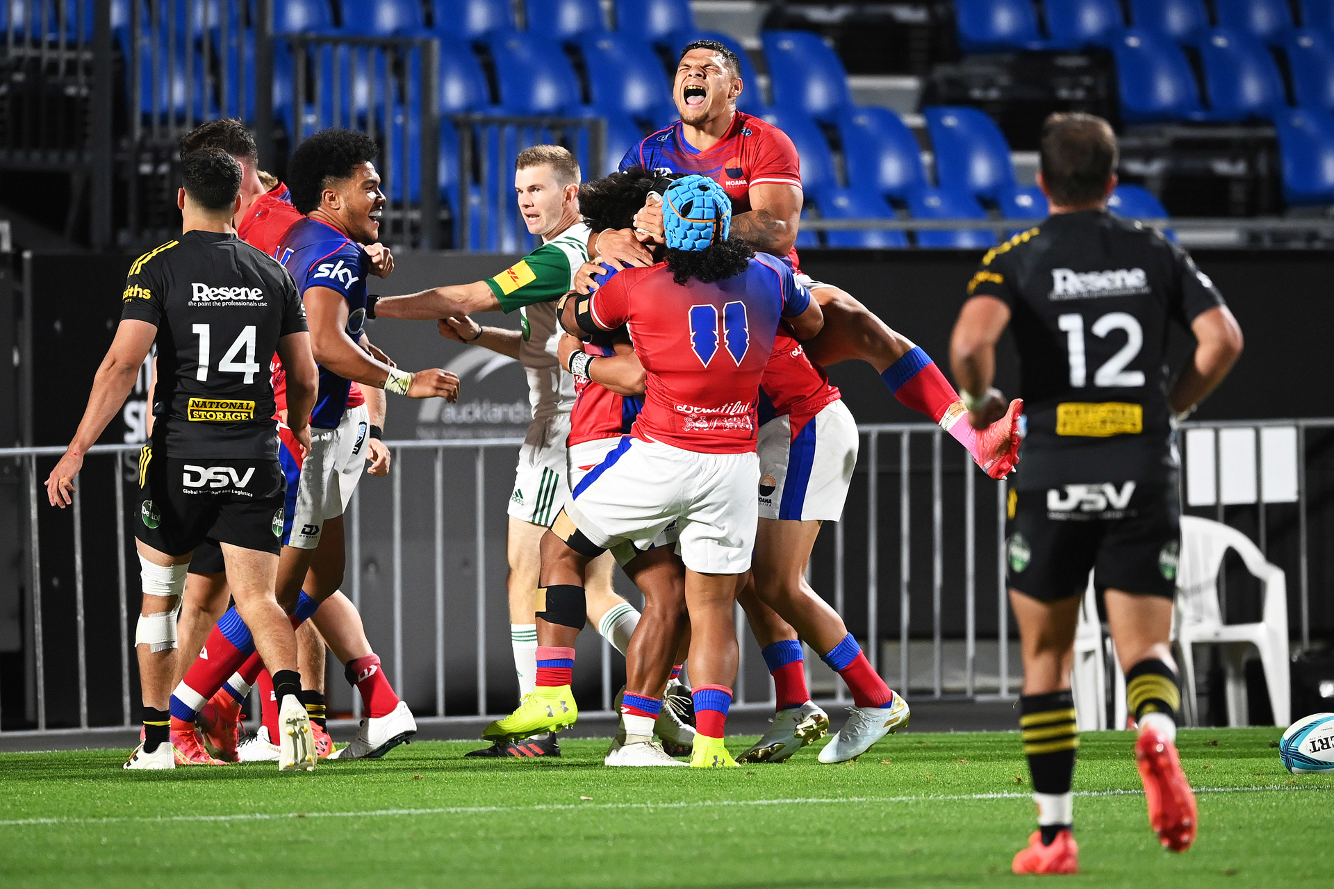 Moana Pasifika players celebrate the winning try by Danny Toala. Photo / Photosport