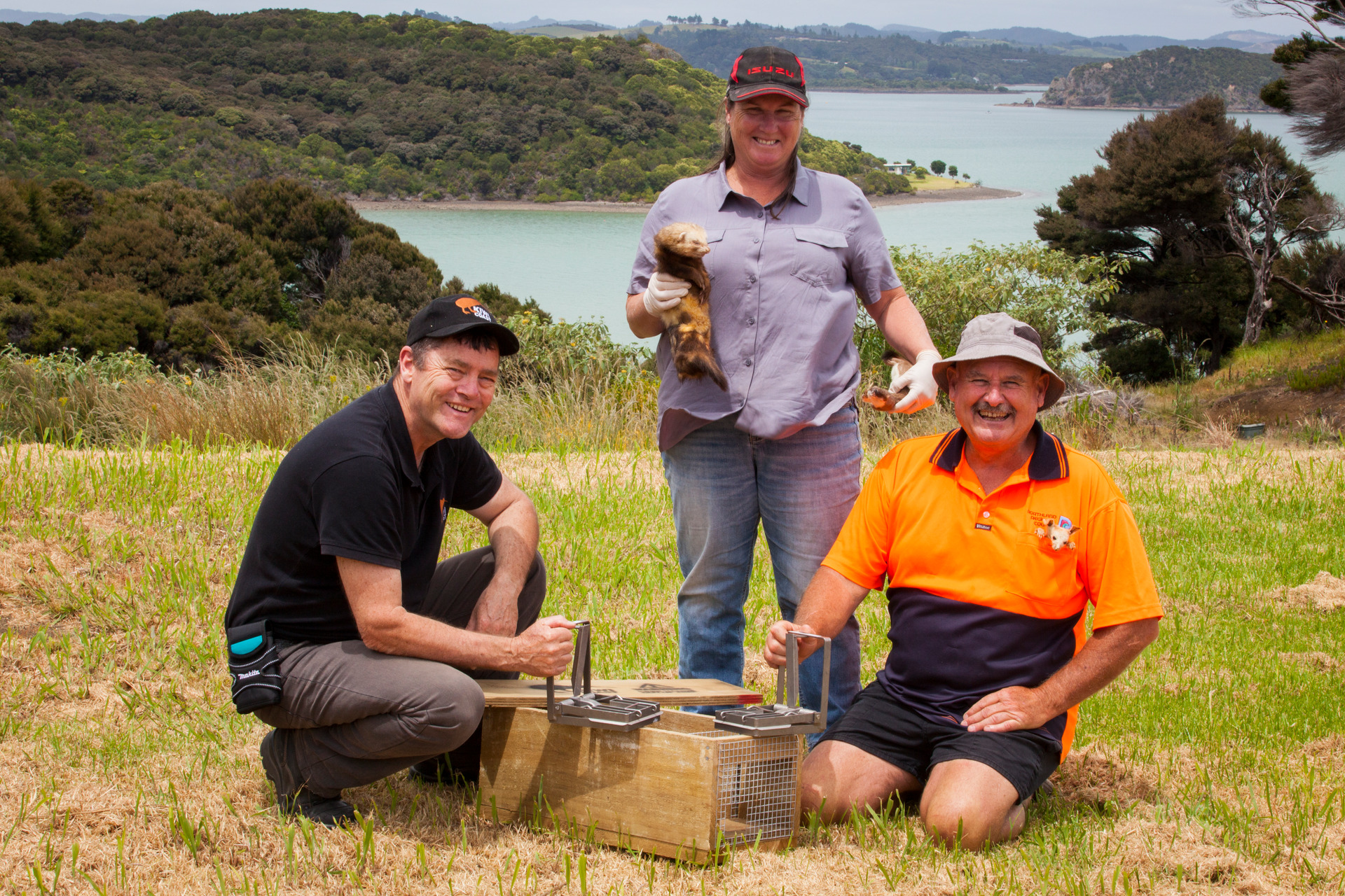 Demonstrating some of the traps used in the Bay of Islands project are, from left, Kiwi Coast co-ordinator Andy Mentor, community trapper Tina Winder and former Northland Regional Council biosecurity officer Mike Knight. Photo / NRC