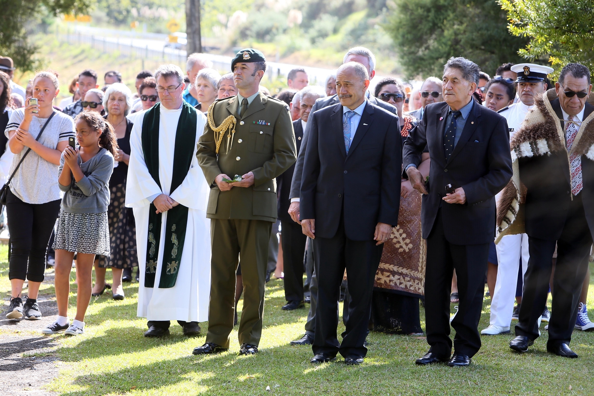 Caught in a solemn moment during the celebration of a life and launch of Esther-Jordan Muriwai's Bronchiectasis Foundation are Joe Clark, Camron Muriwai with Justice Muriwai, and Father Peter McDermott from St Francis Xavier Catholic Church.