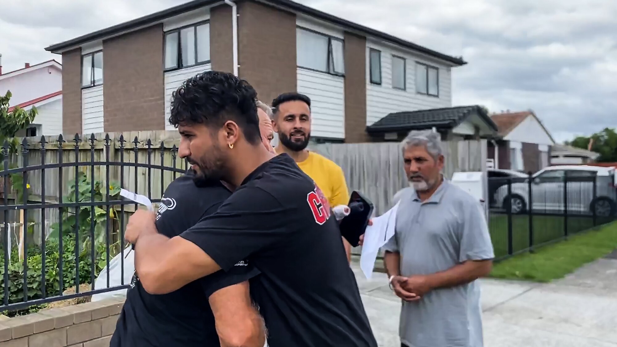 Davinder Singh hugs Paul Dore, thanking him for saving his father. Photo / Cherie Howie