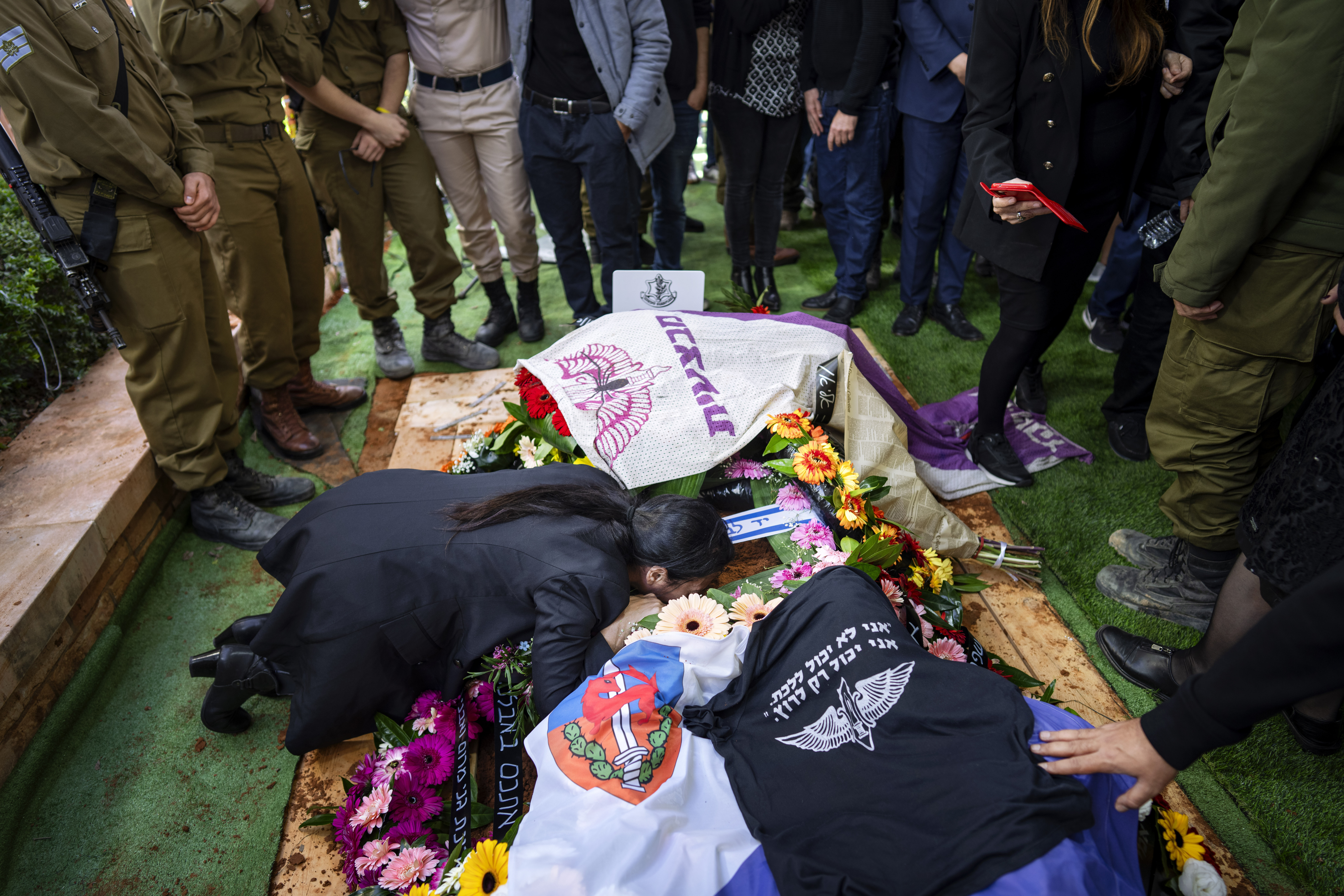 Family and friends of Israeli soldier Lieutenant Yaacov Elian mourn over his grave during his funeral at Kiryat Shaul cemetery in Tel Aviv, Israel. Photo / AP