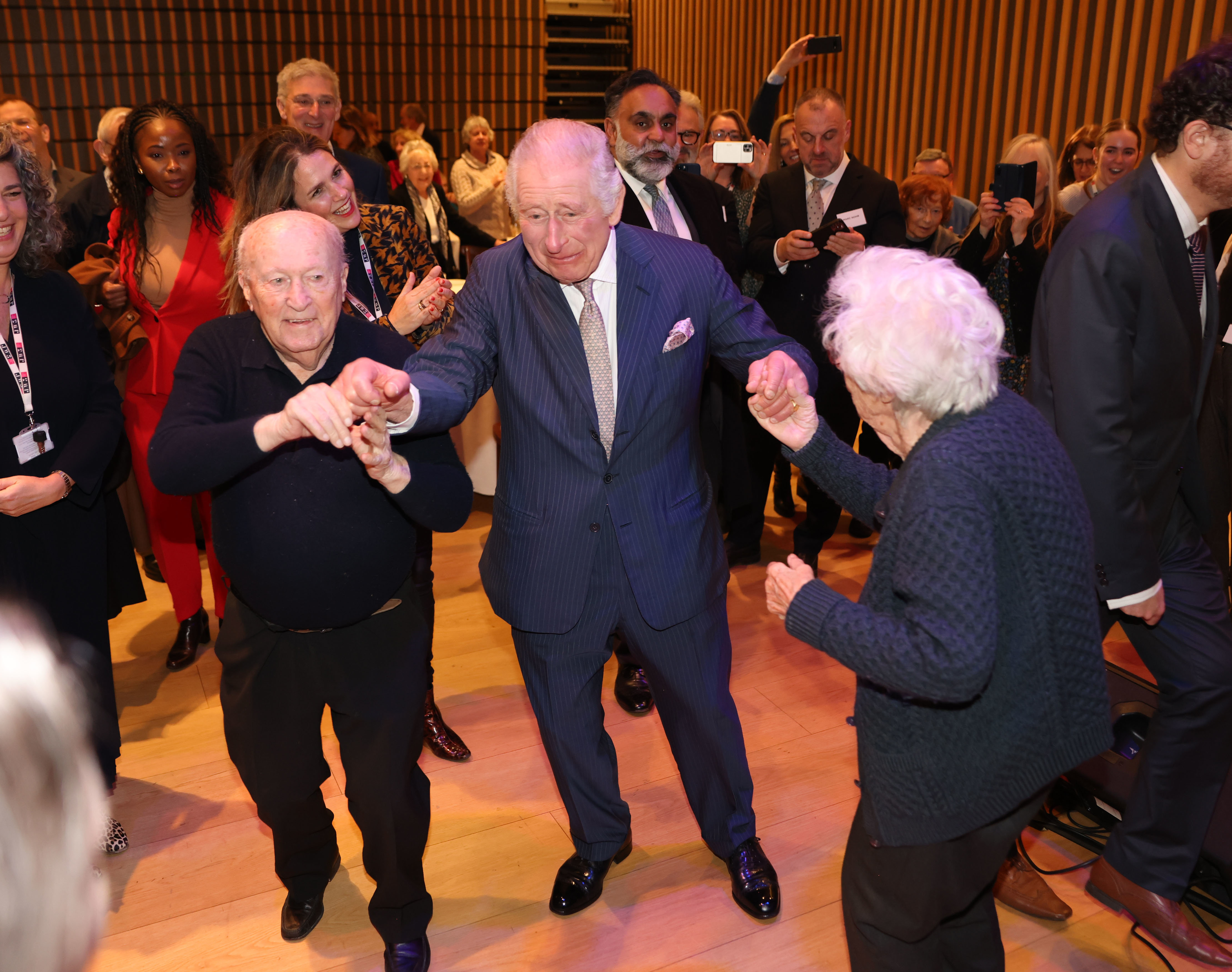 King Charles III dances at a pre-Chanukah reception hosted on-site for Holocaust survivors at the JW3 Community Centre on December 16 in London, England. Founded by Dame Vivien Duffield DBE, JW3 opened in October 2013 with a vision of a vibrant, diverse, unified British-Jewish community, inspired by and engaged with Jewish arts, culture, learning and life. (Photo / WPA Pool/Getty Images)