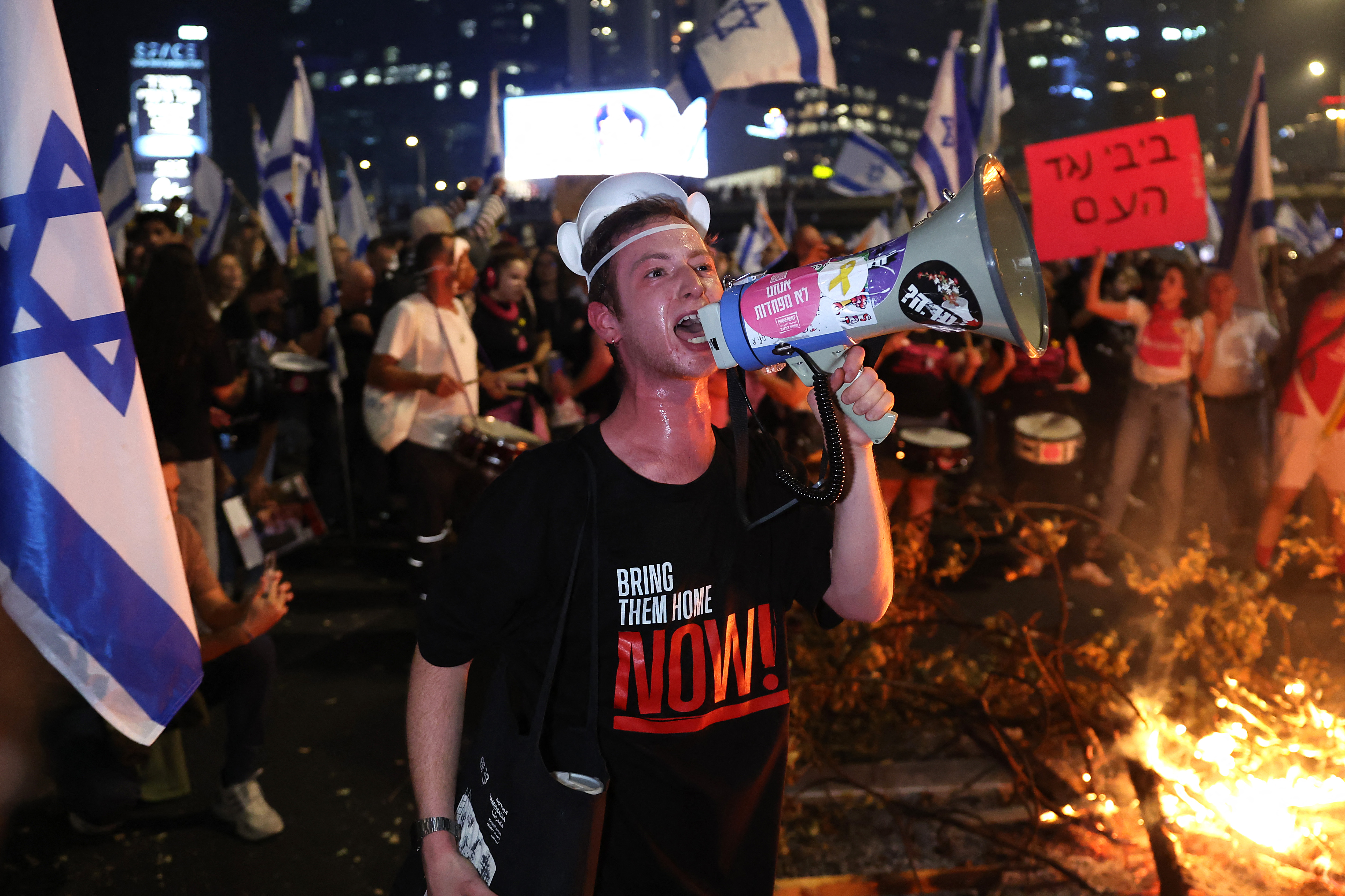Israeli protesters block a road in Tel Aviv after the dismissal of the defence minister. Photo / AFP