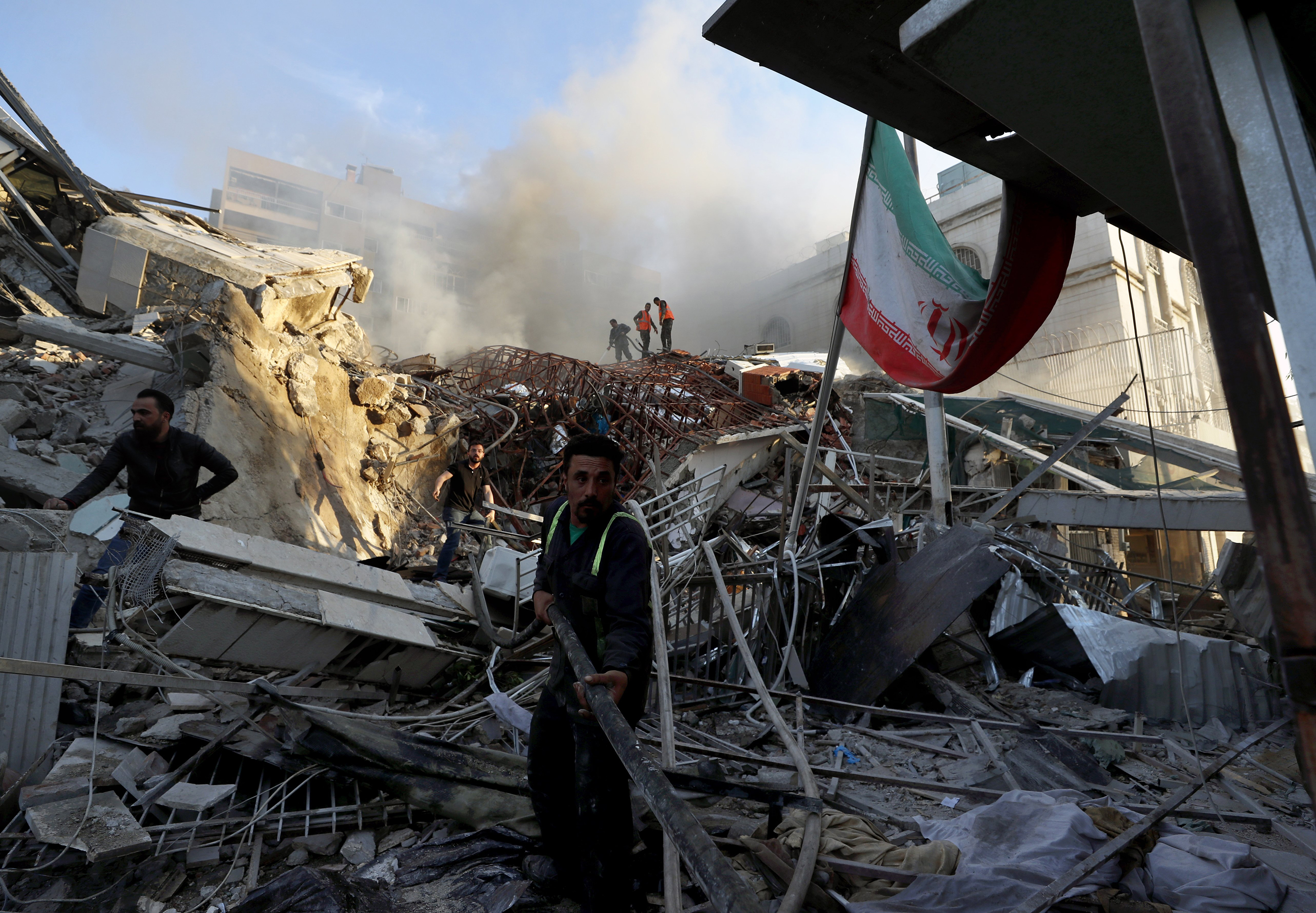 Emergency services at a destroyed building hit by an air strike in Damascus, Syria, on April 1. An Israeli airstrike destroyed the consular section of Iran's embassy in Damascus, killing or wounding everyone inside, Syrian state media said. Photo / AP