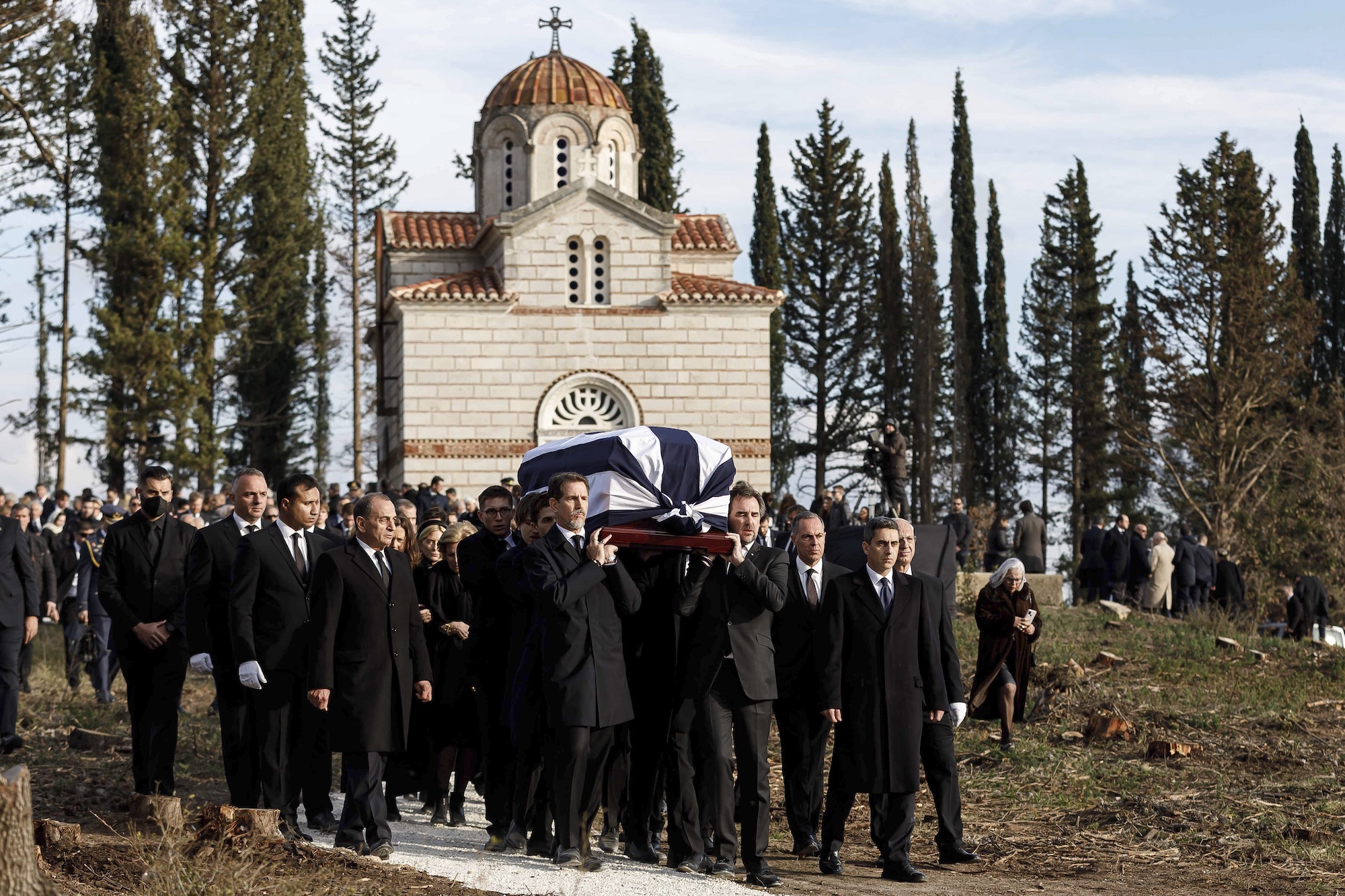 Prince Pavlos, left, and Prince Nikolaos, right, sons of former king of Greece Constantine II, carry the coffin of their father at the cemetery of the former summer residence of Greece's royals, in Tatoi, northwestern Athens. Photo / AP