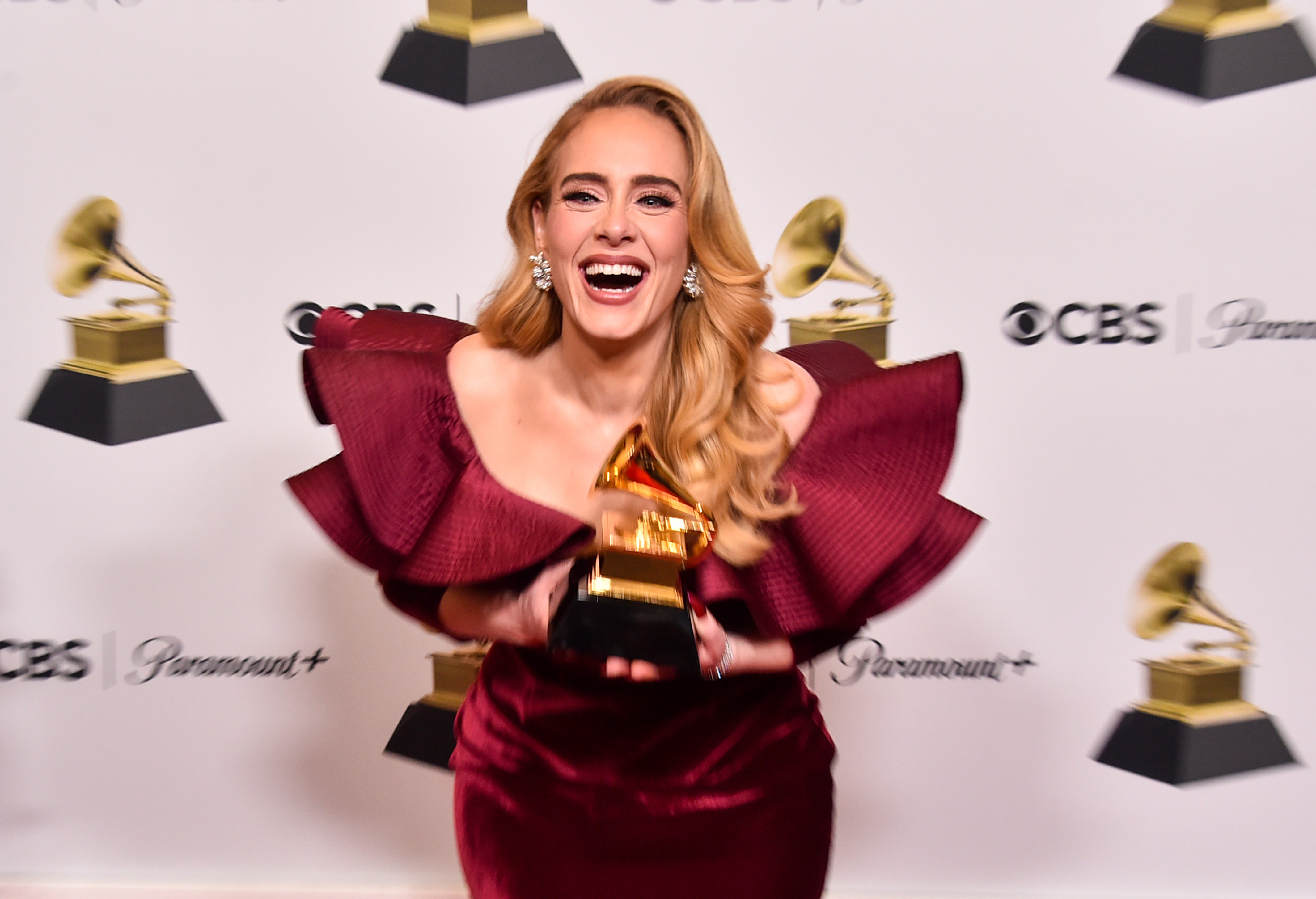 Adele poses with the Best Pop Solo Performance Award for