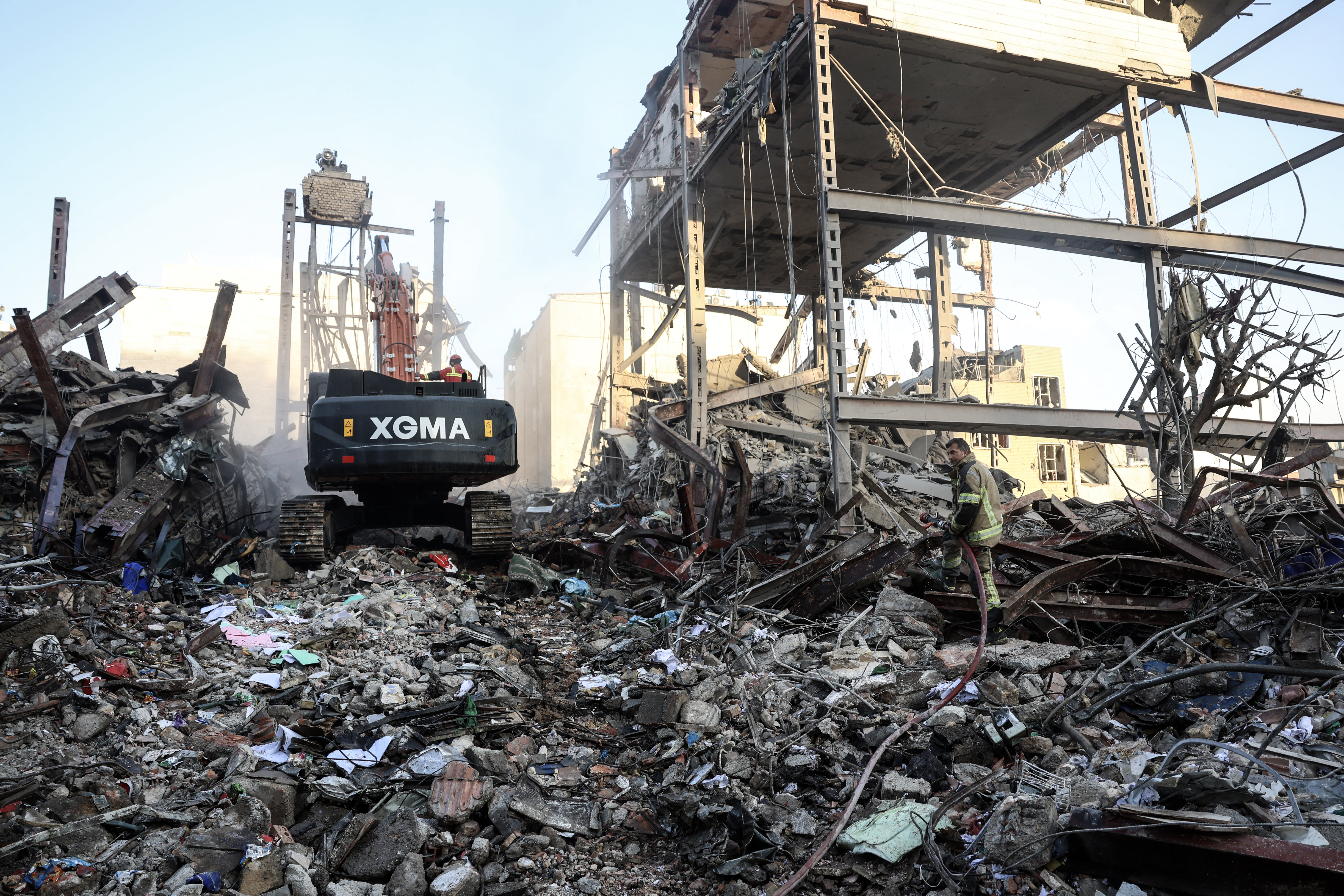 A firefighter stands on the rubble of residential buildings near Niloufar square in Tehran during the ongoing joint US-Israeli military campaign on Iran. Photo / AFP