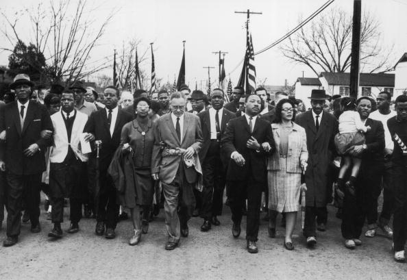 American civil rights campaigner Martin Luther King and his wife Coretta Scott King lead a black voting rights march. Photo / Getty Images