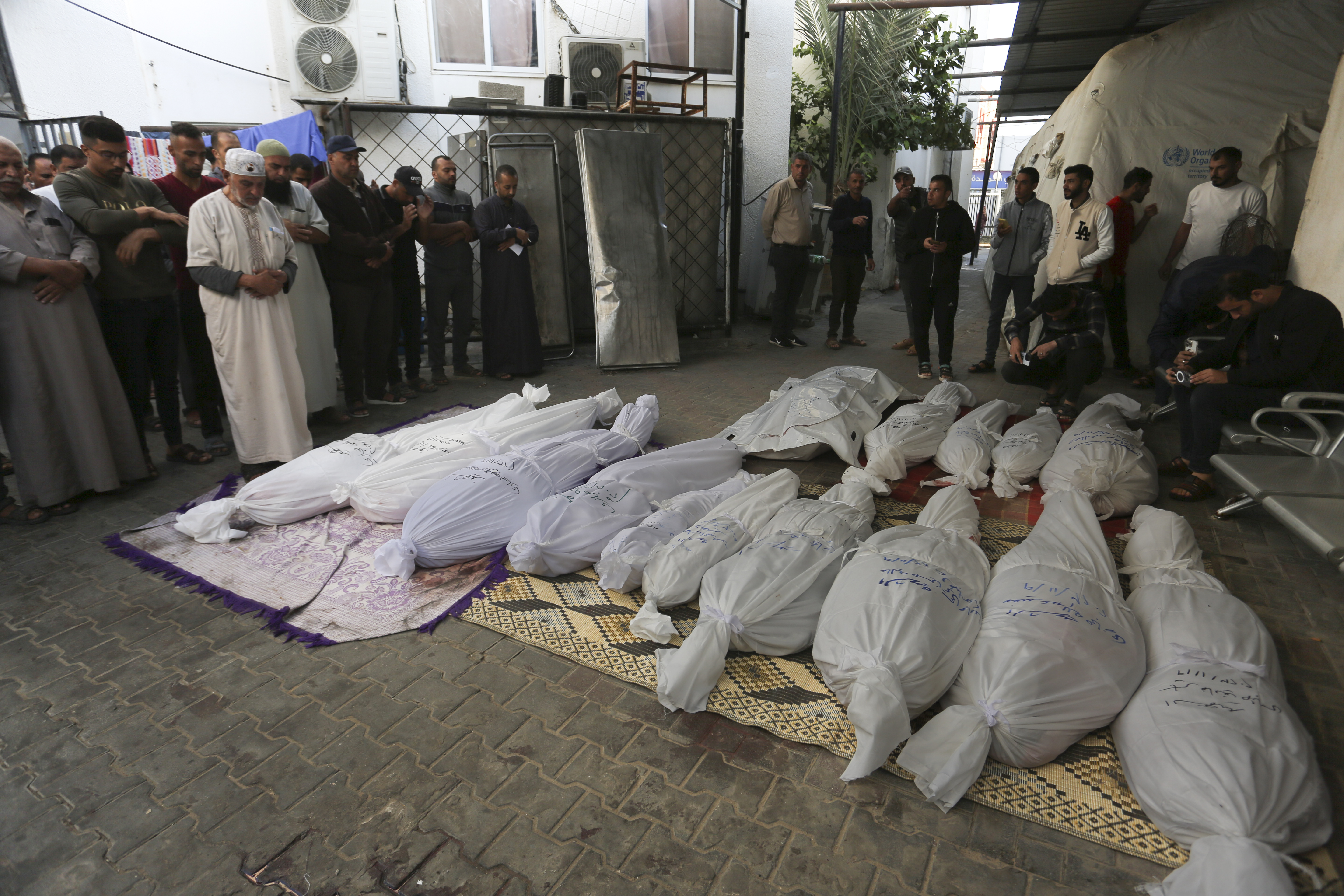 Palestinians pray by the bodies of the Hijazi family that was killed in the Israeli bombardment of the Gaza Strip in Rafah on Friday. Photo / AP