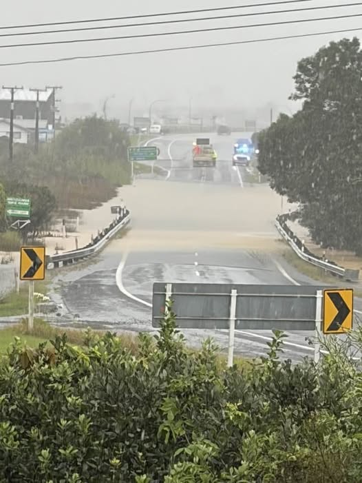 Floodwaters cover the highway on the outskirts of Whitianga, which is cut off from the rest of the Coromandel Peninsula.