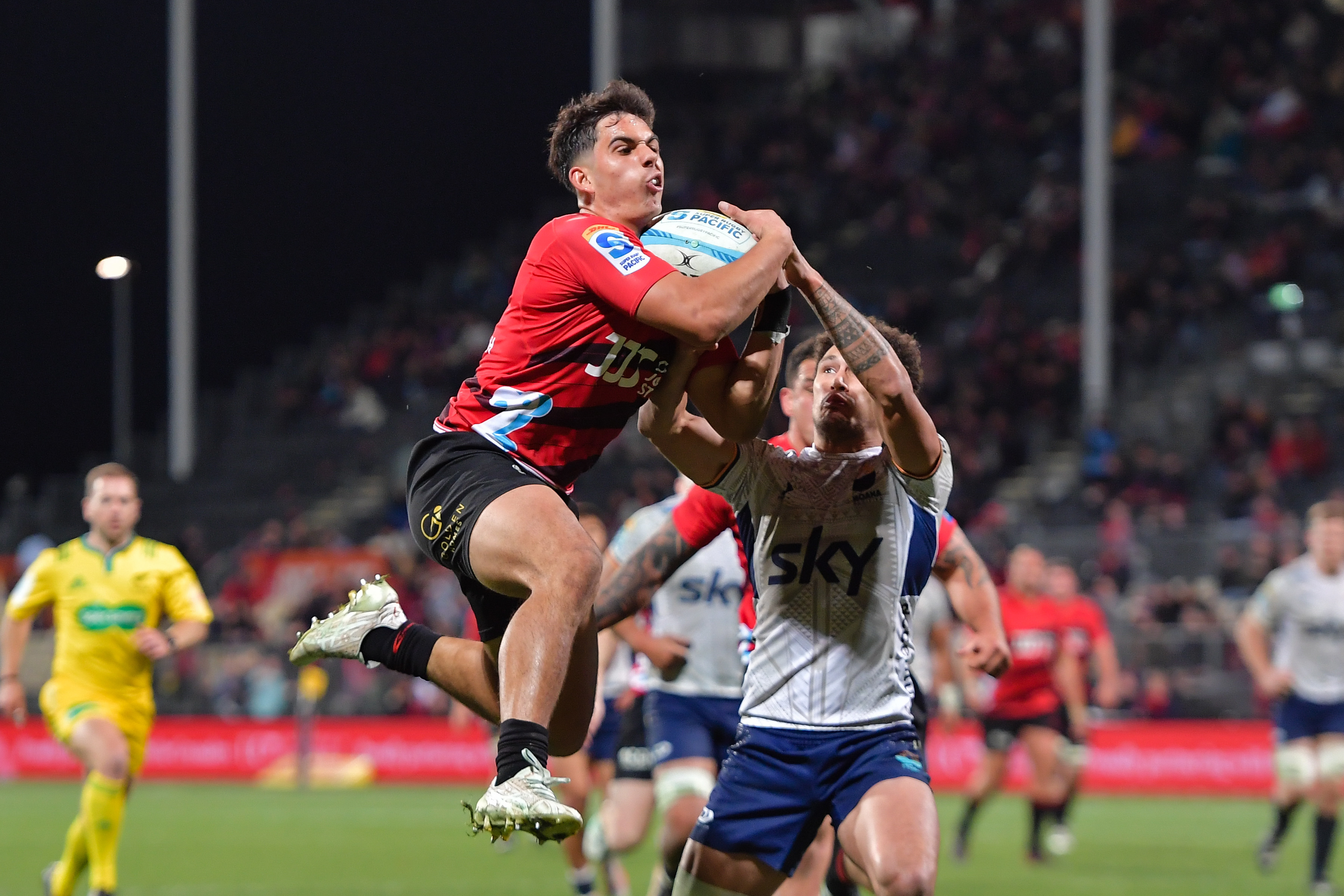 The Crusaders' Noah Hotham grabs the ball from Moana Pasifika's William Havili, going on to score. Photo / Photosport