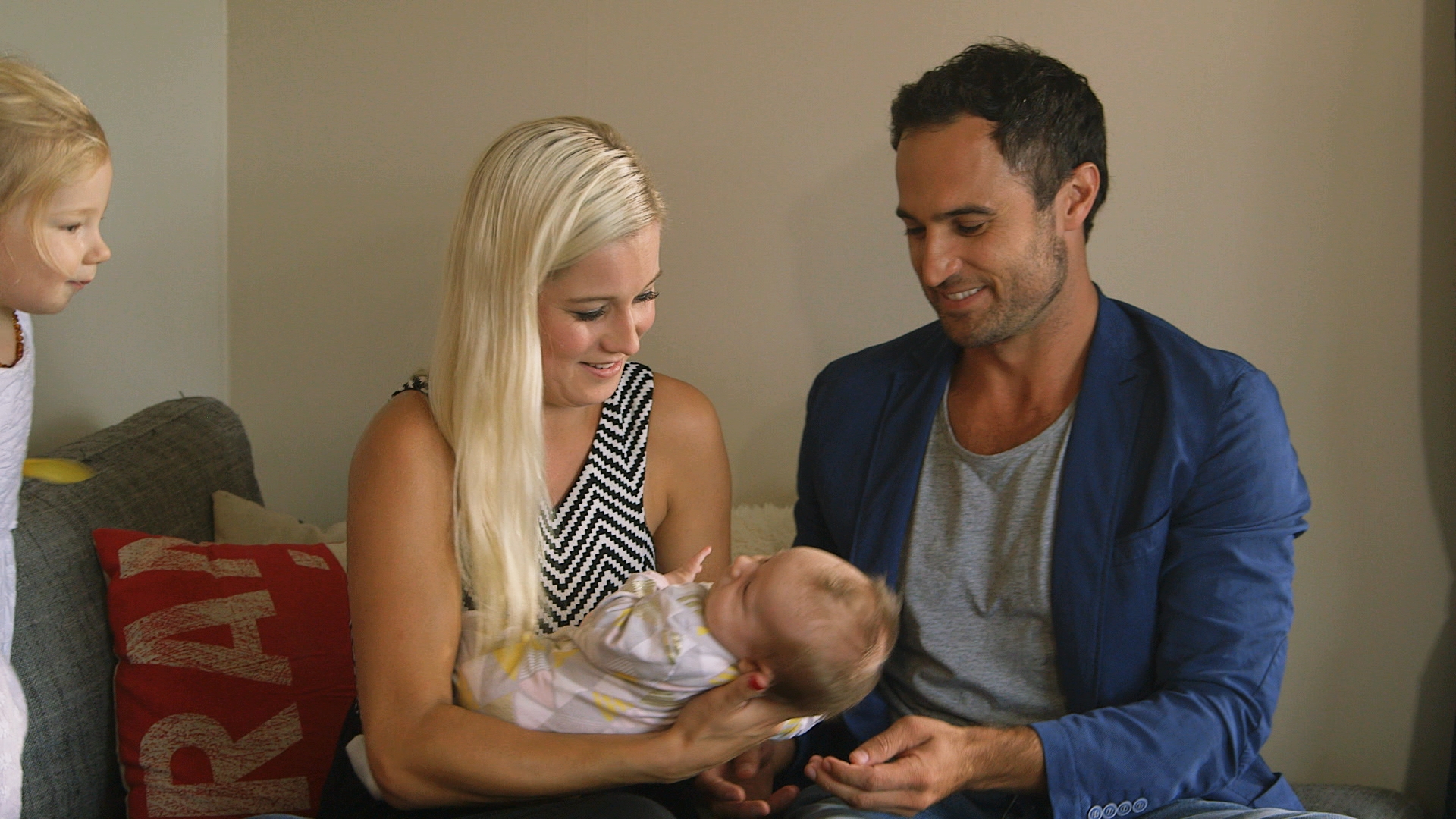 Jordan with a baby (not his) and Fleur Verhoeven, one of the finalists on The Bachelor NZ. Photo/TV3