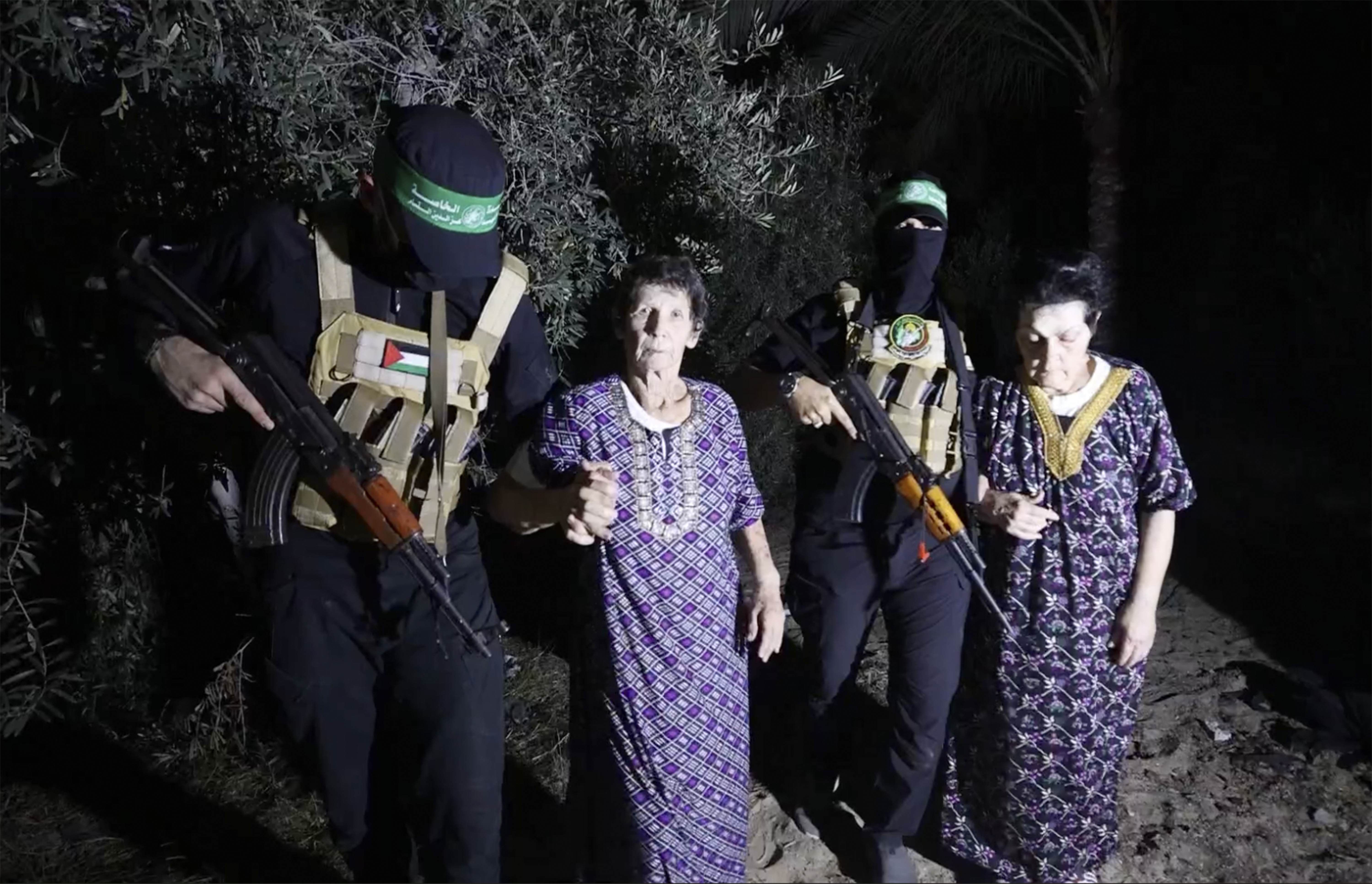 This image taken from video released by Al Qassam brigades on its Telegram channel, shows Yocheved Lifshitz, 85, center, and Nurit Cooper, 79, being escorted by Hamas as they are released to the Red Cross in an unknown location. Photo / AP