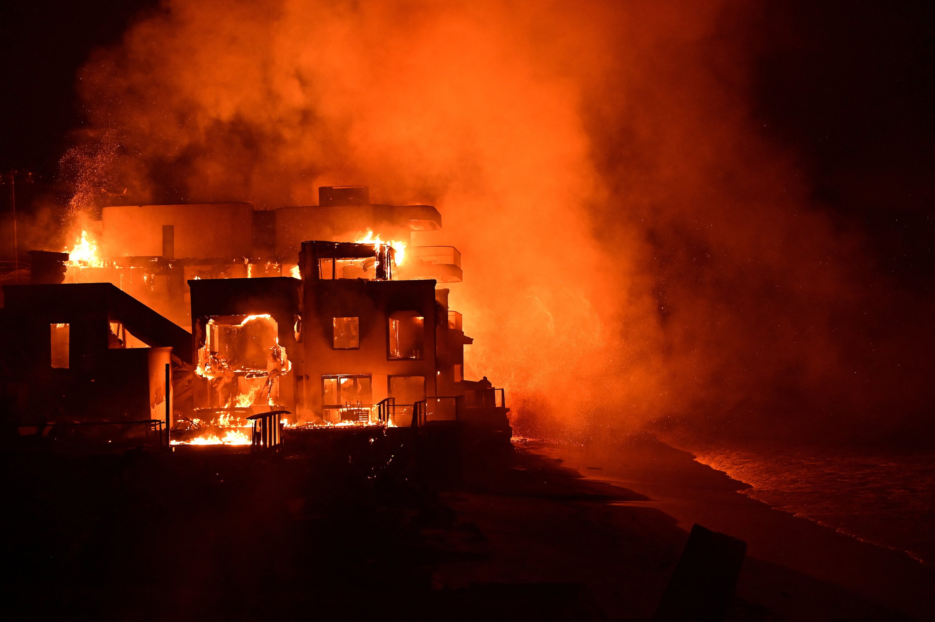 A beach house is engulfed in flames as the Palisades Fire burns along Pacific Coast Highway in Malibu, California. Photo / AFP