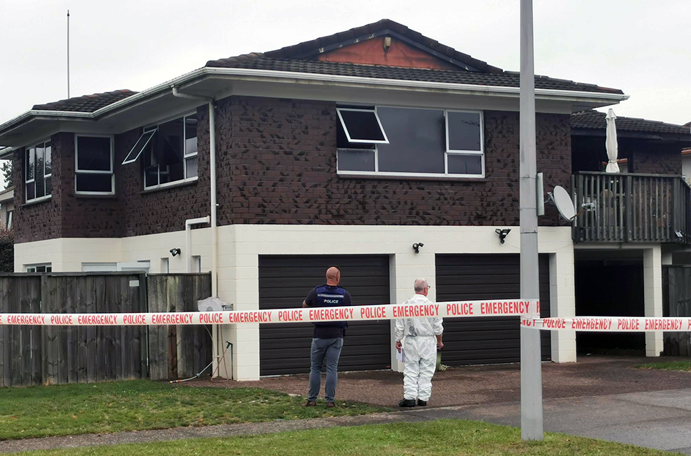 Investigators at the scene of the Newbrooks' house fire in February. Photo / Andrew Warner
