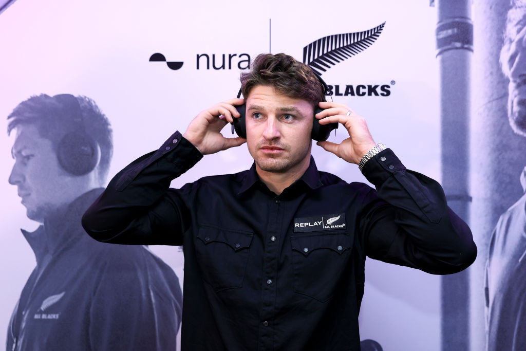 Beauden Barrett tries out a pair of Nura headphones during a New Zealand Rugby and Nura partnership announcement at New Zealand Rugby House. Photo / Getty