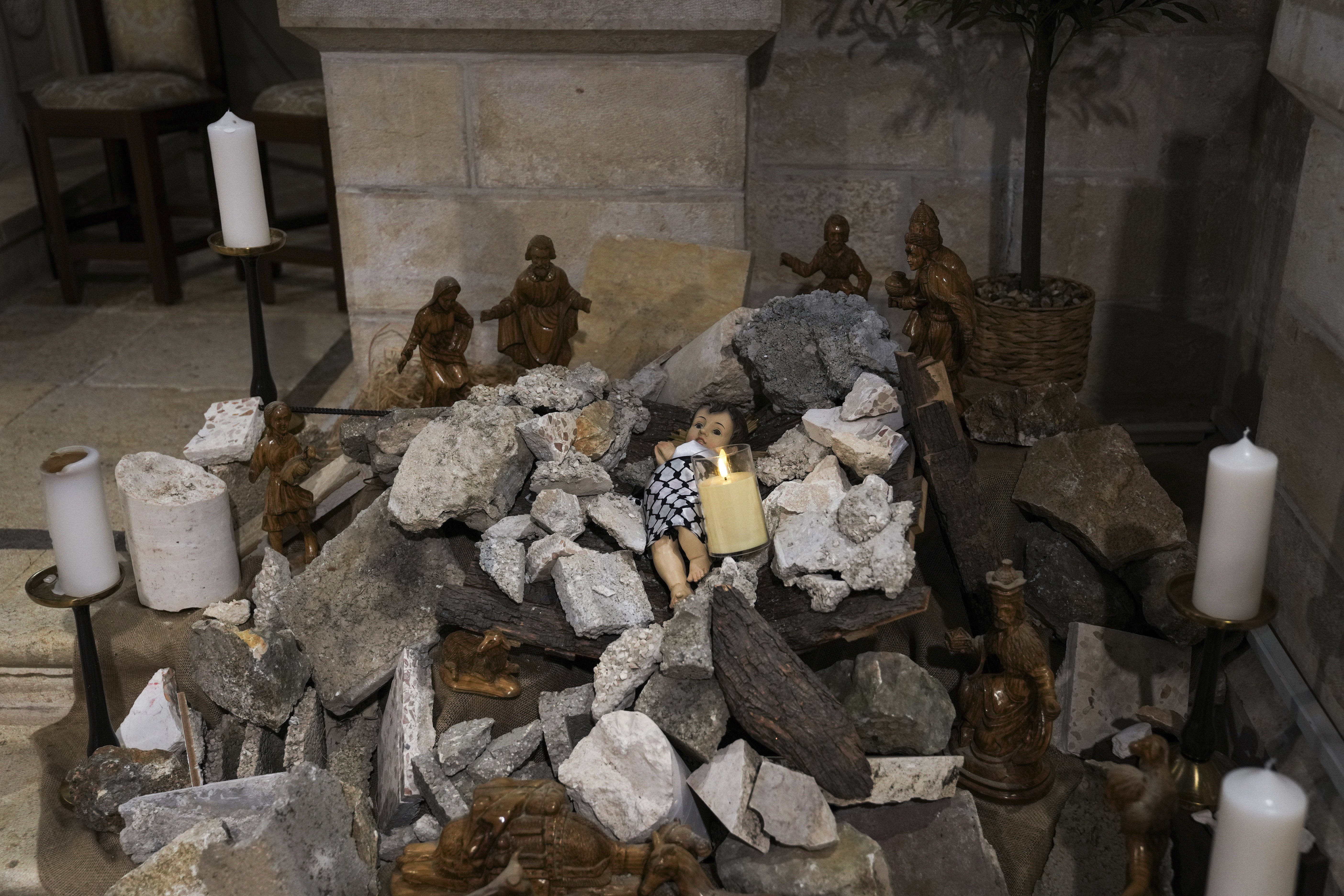 An installation of a scene of the Nativity of Christ with a figure symbolising baby Jesus lying amid the rubble, in reference to Gaza, inside the Evangelical Lutheran Church in the West Bank town of Bethlehem. World-famous Christmas celebrations in Bethlehem have been put on hold due to the ongoing Israel-Hamas war. Photo / AP