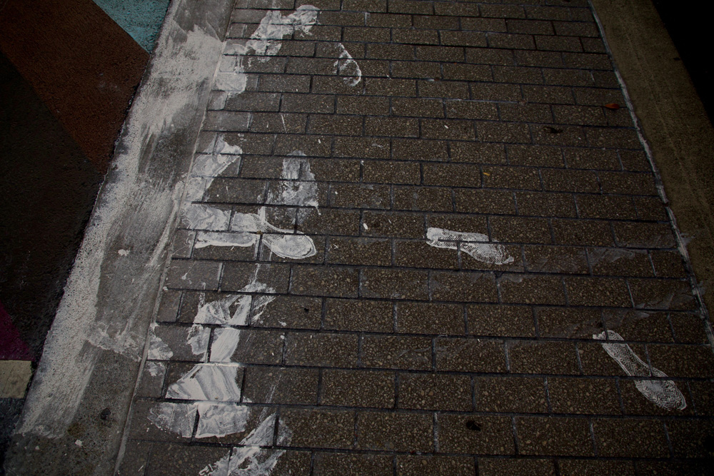 White paint has been spread along the road and footpath by pedestrians and drivers after the rainbow crossing was painted over. Photo / Michael Craig