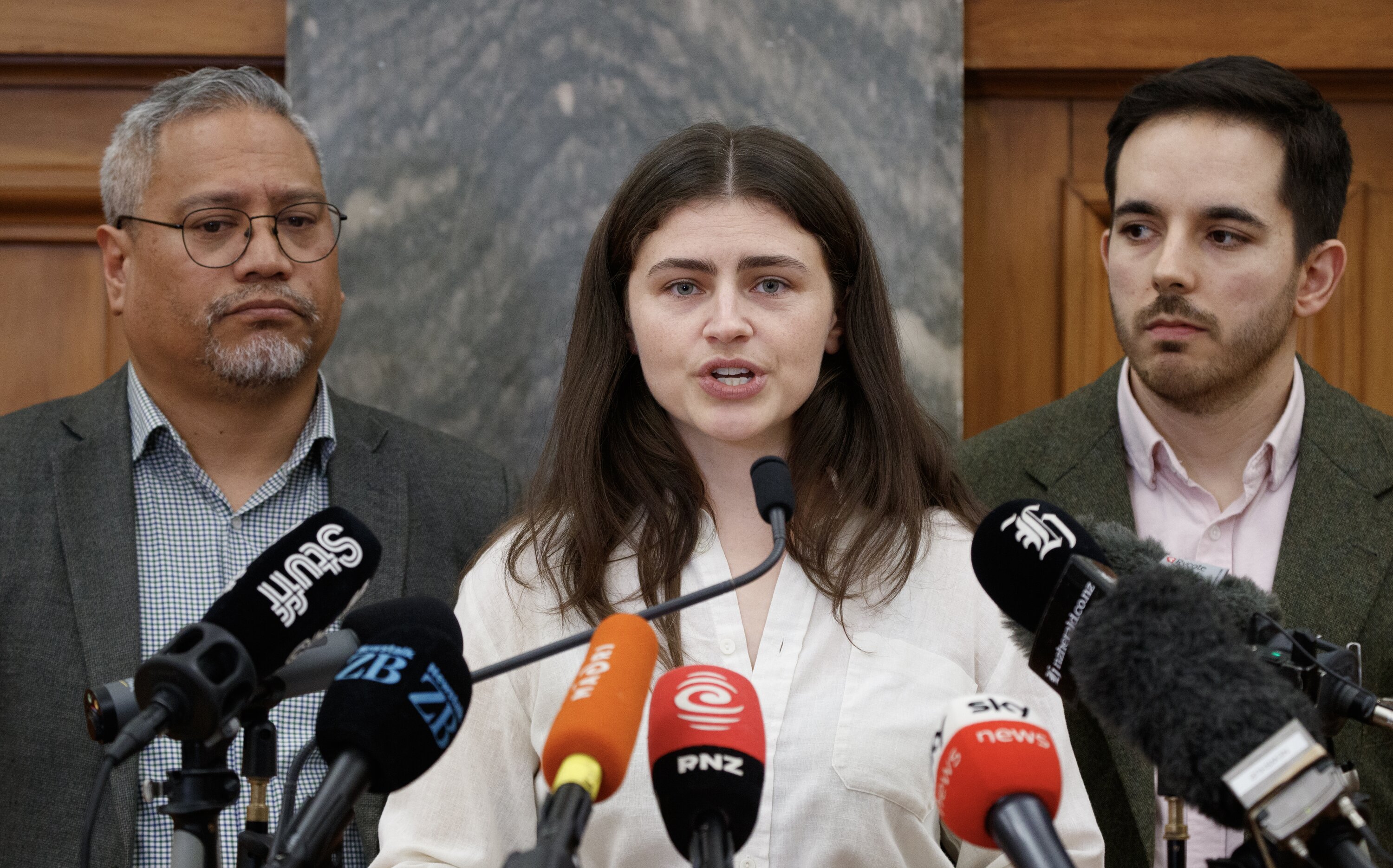 Green Party co-leader Chlöe Swarbrick, with colleagues Teanau Tuiono and Ricardo Menendez March, announcing the party has asked MP Darleen Tana to resign. Photo / Mark Mitchell
