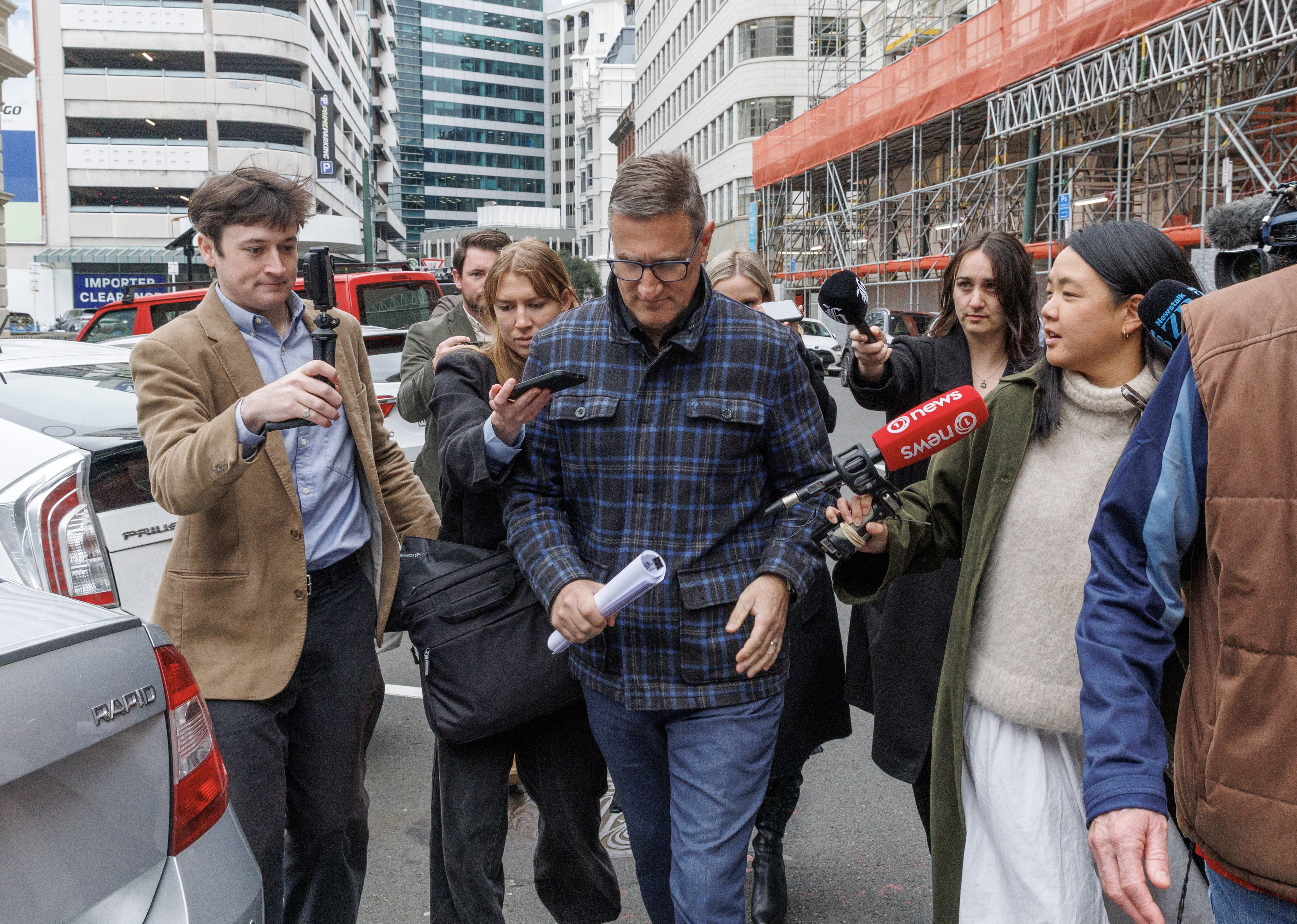 Jevon McSkimming leaves the Wellington District Court, pursued by reporters, after he appeared on charges of possessing child exploitation and bestiality material. Photo / Mark Mitchell