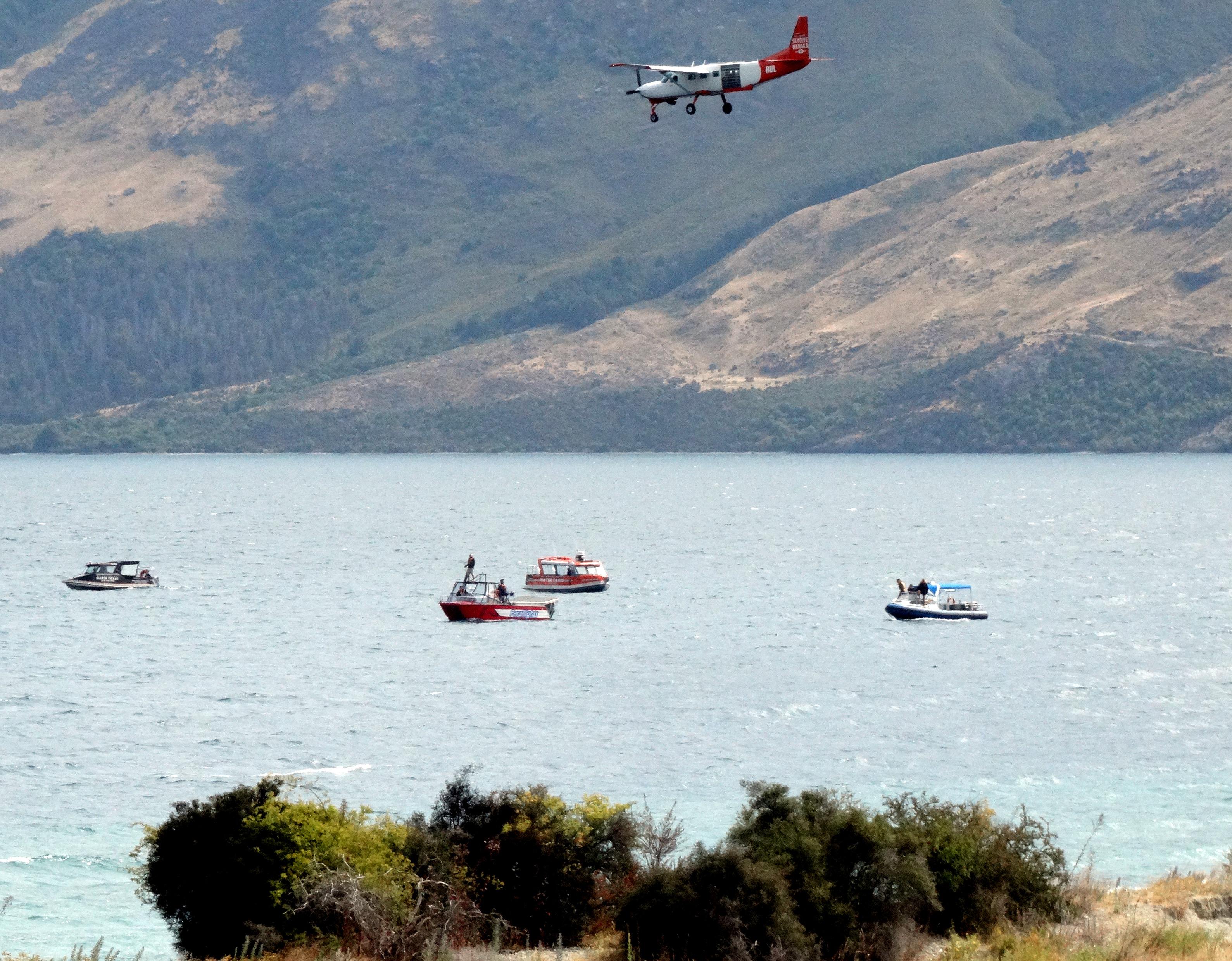 Planes, boats and jet-skis search for a missing skydiver in Queenstown's Lake Wakatipu on Tuesday. Photo / Mandy Cooper