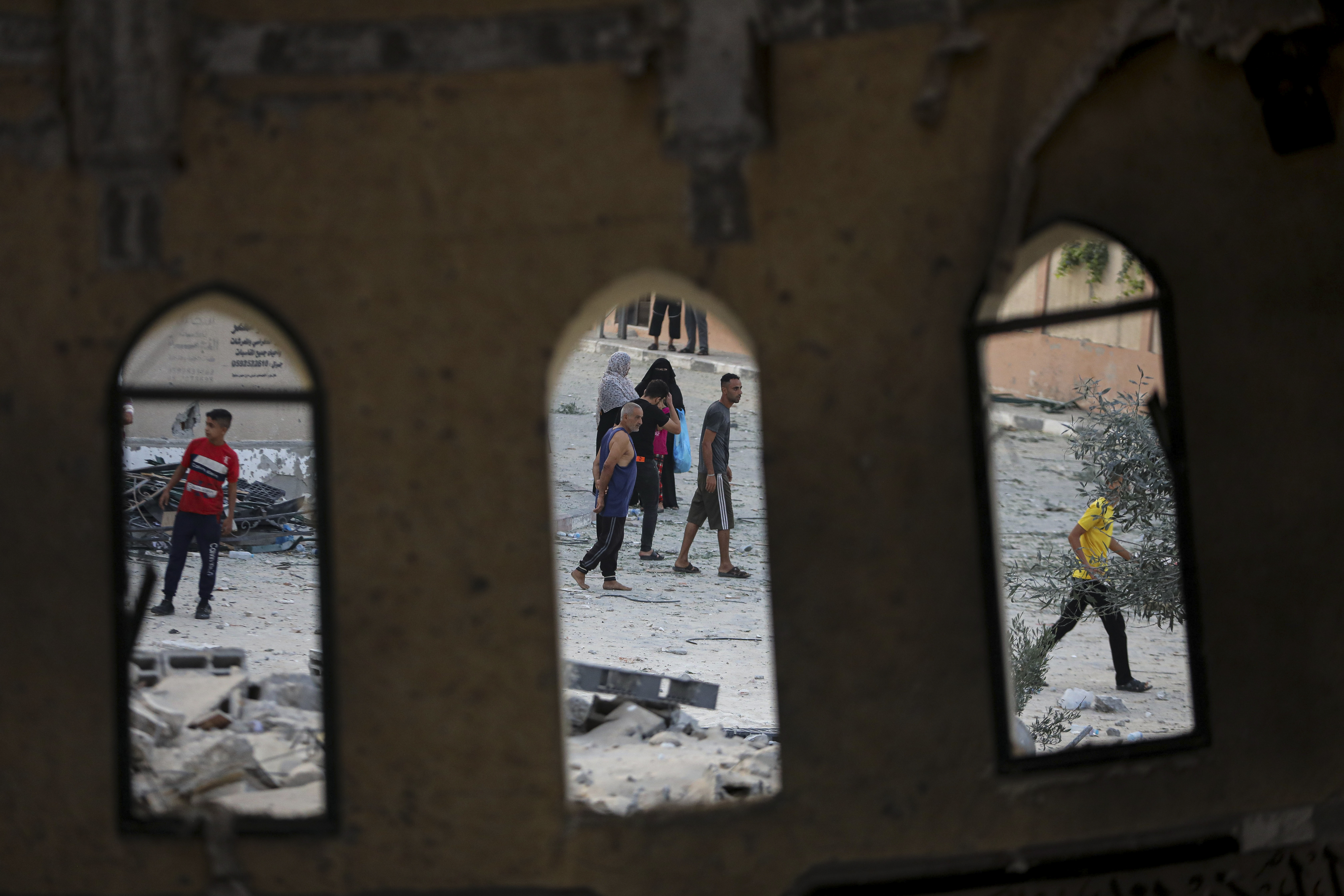 People stand outside a mosque destroyed in an Israeli air strike in Khan Younis, Gaza Strip. Photo / AP