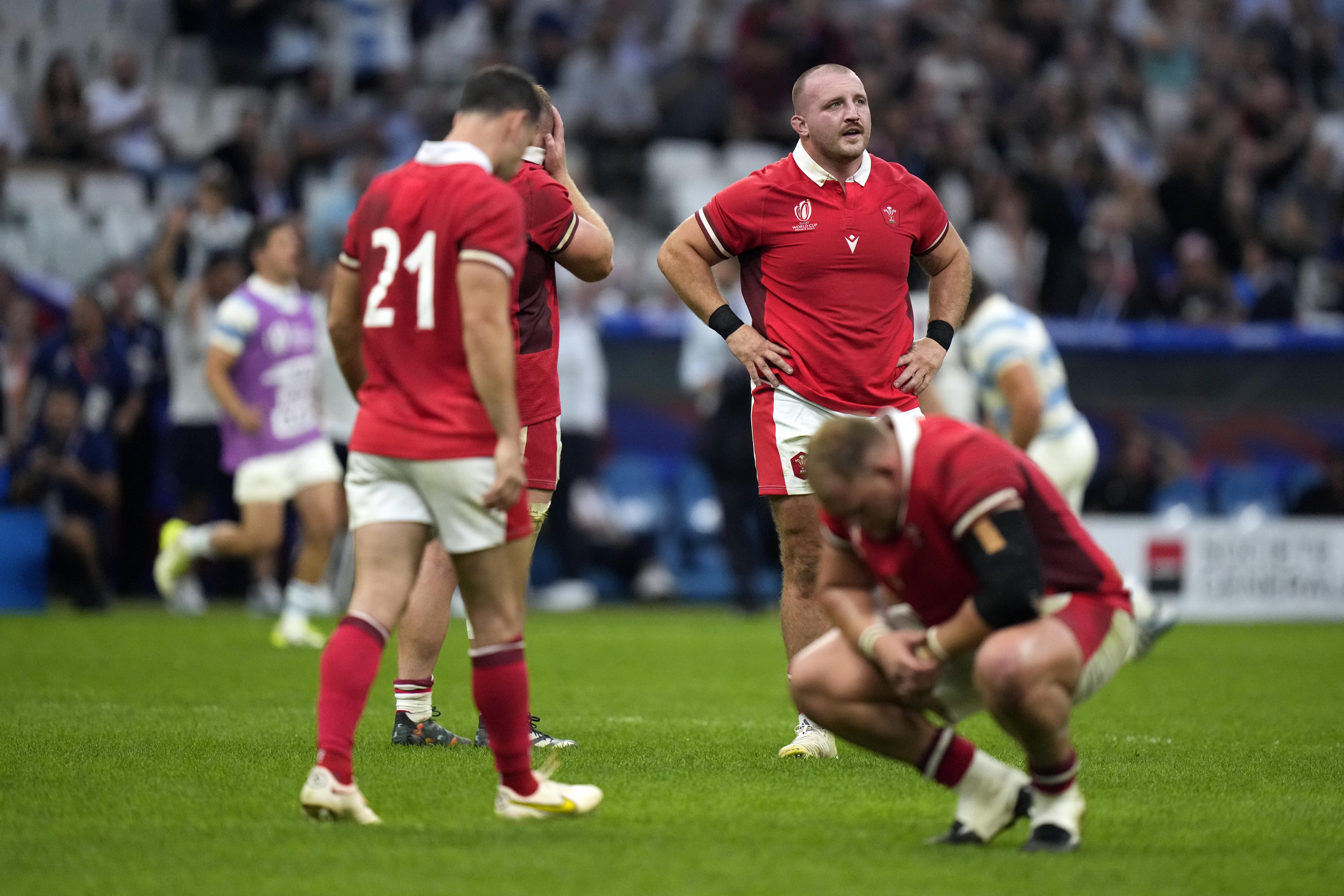 Wales players react after losing the Rugby World Cup quarter-final to Argentina. Photo / AP