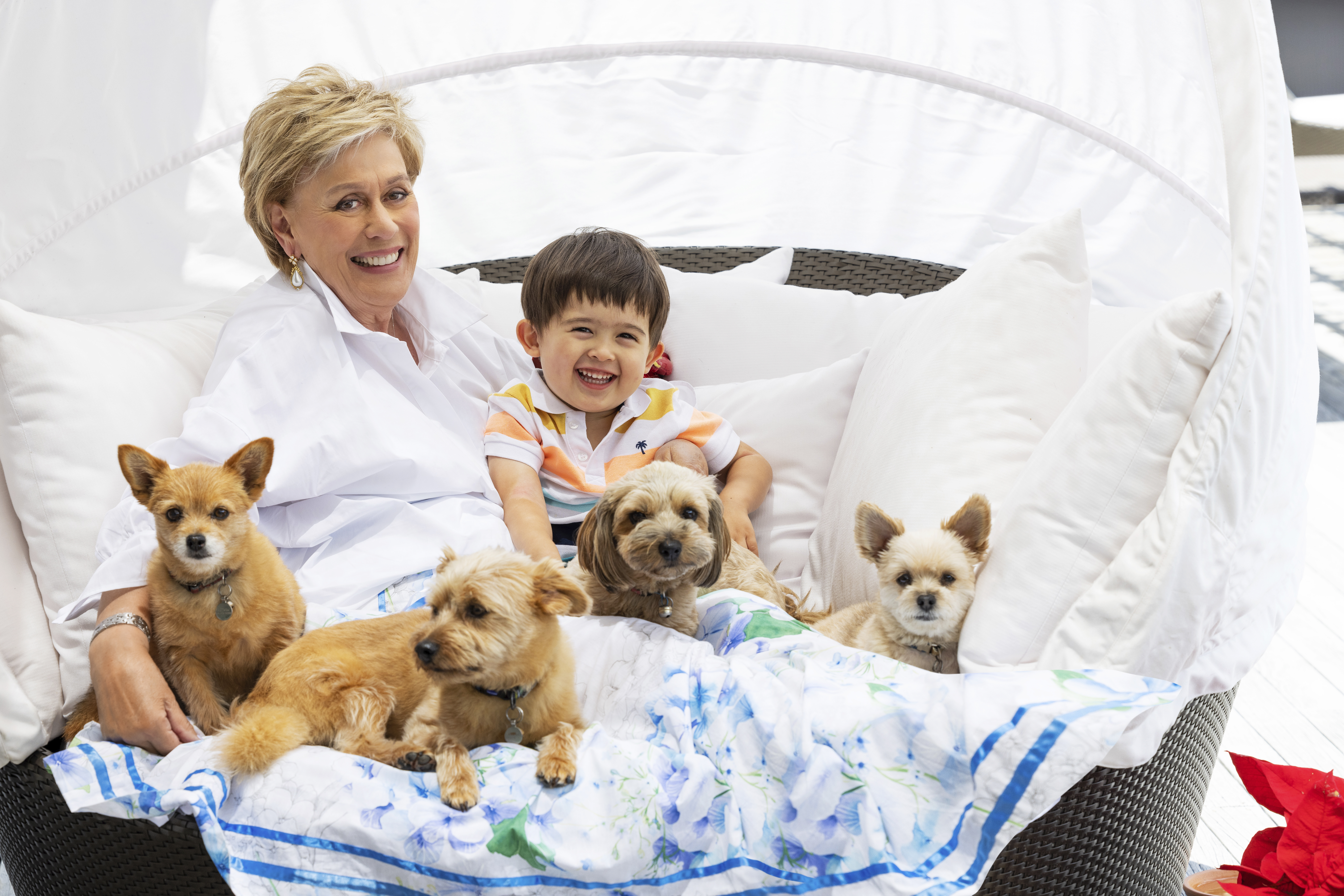 Dame Kiri Te Kanawa with her grandson Luther and her four dogs at her Bay of Islands home. Photo / Jae Frew, New Zealand Woman's Weekly  