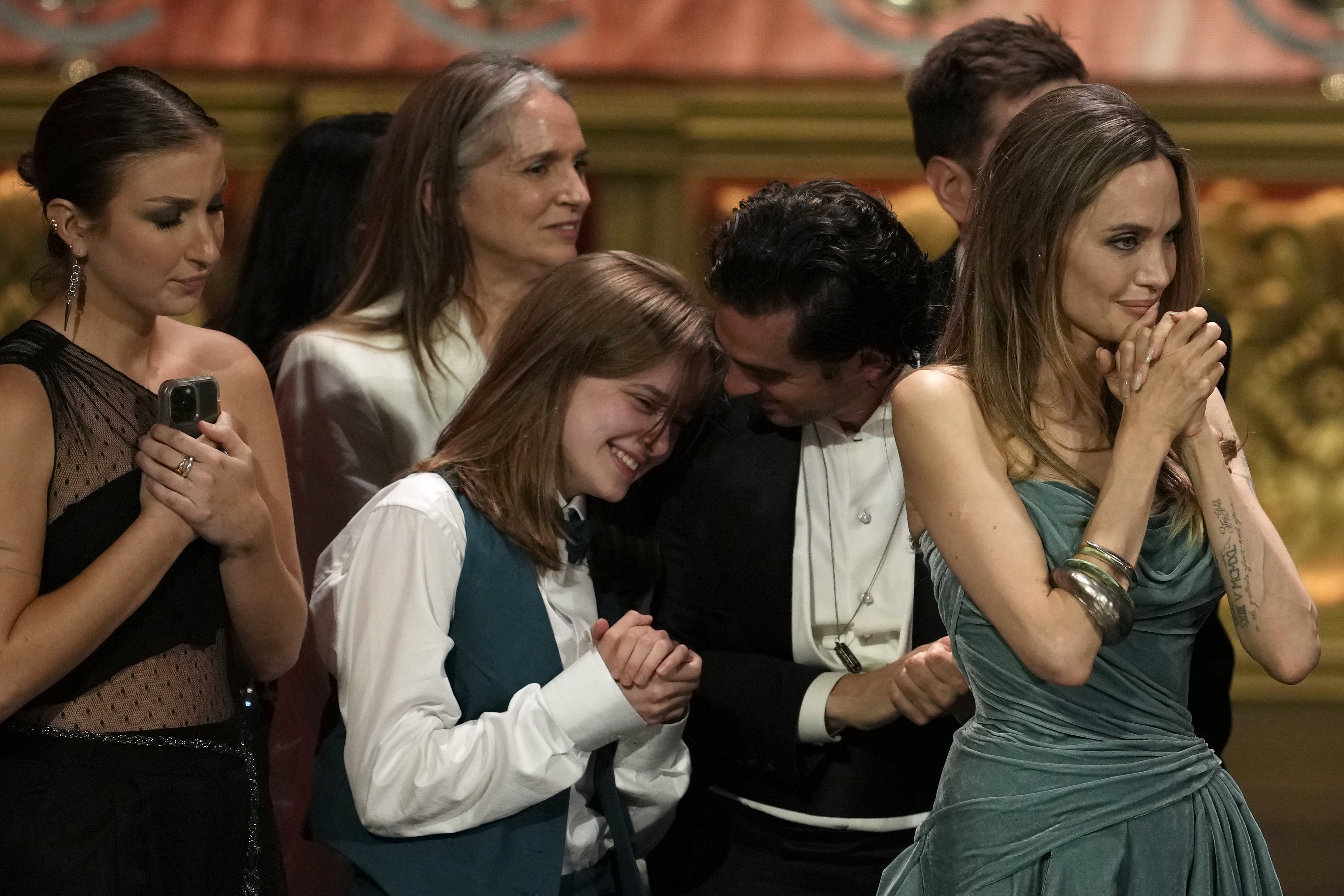 Vivienne Jolie-Pitt, from left, Justin Levine, Angelina Jolie, and members of the company of 'The Outsiders' during the 77th Tony Awards. Photo / AP