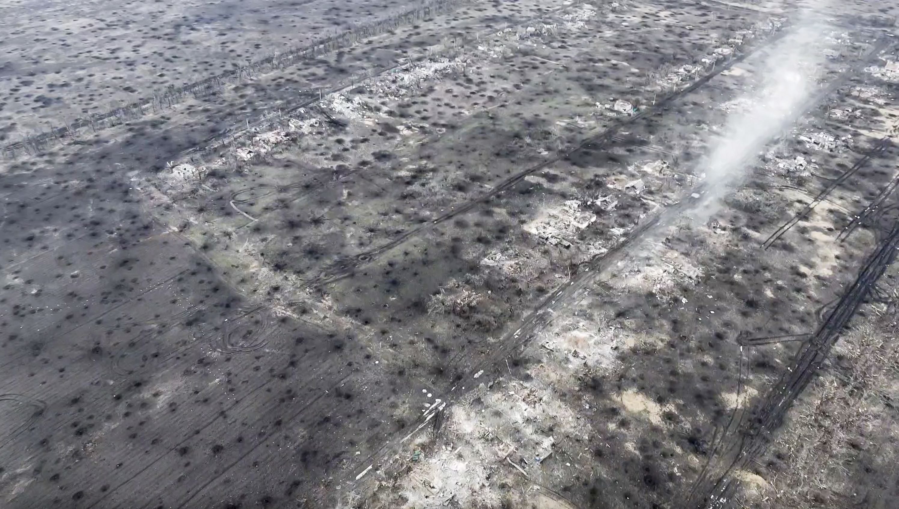 Screengrab of Ukrainian drone footage shows the ground covered with craters from artillery shell explosions in the destroyed village of Stepove near Avdiivka, Ukraine. Photo / AP