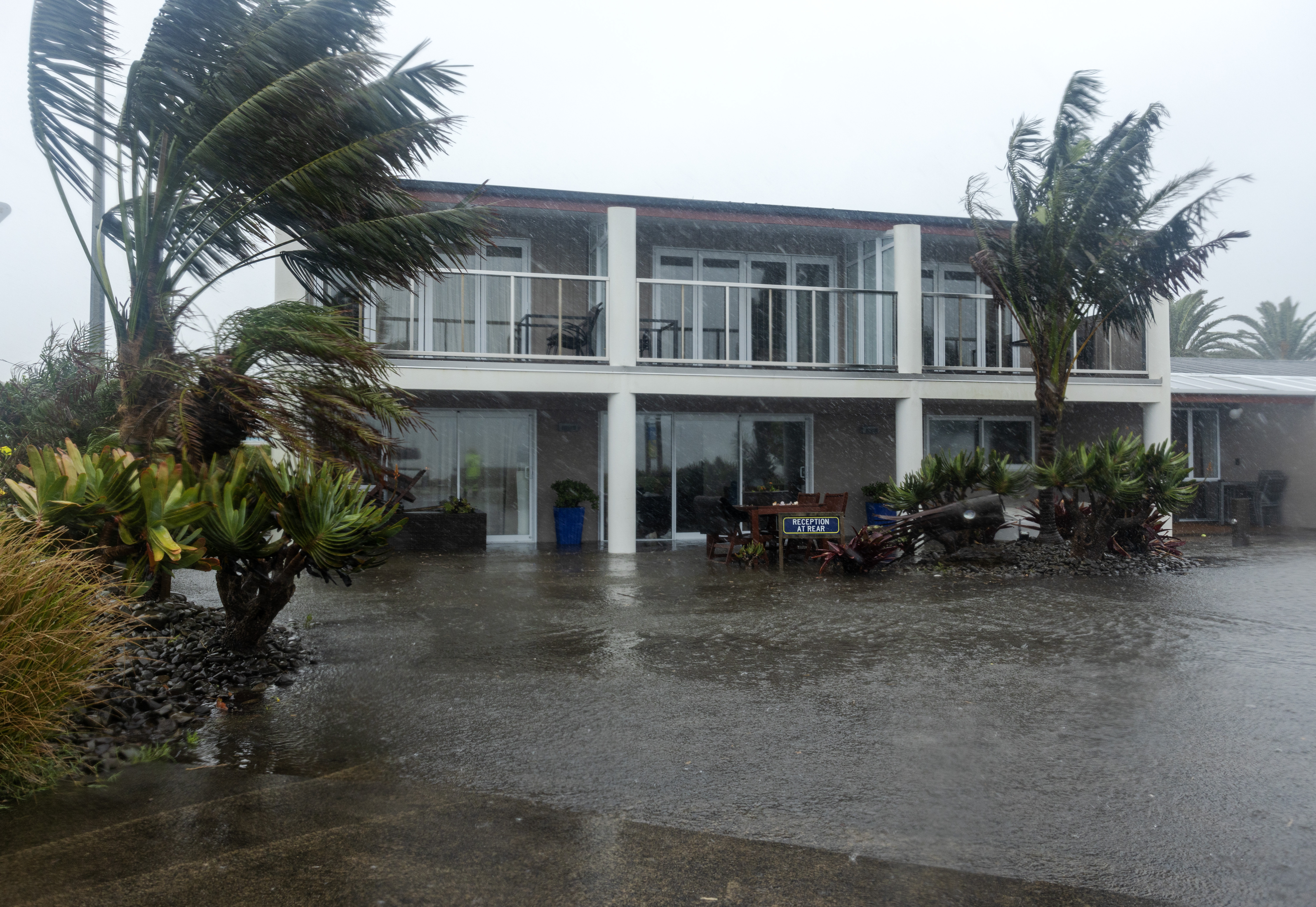 Bayfair on the Beach motel began to get flooded as seawater flowed over the road after Cyclone Gabrielle. Photo / Mike Scott