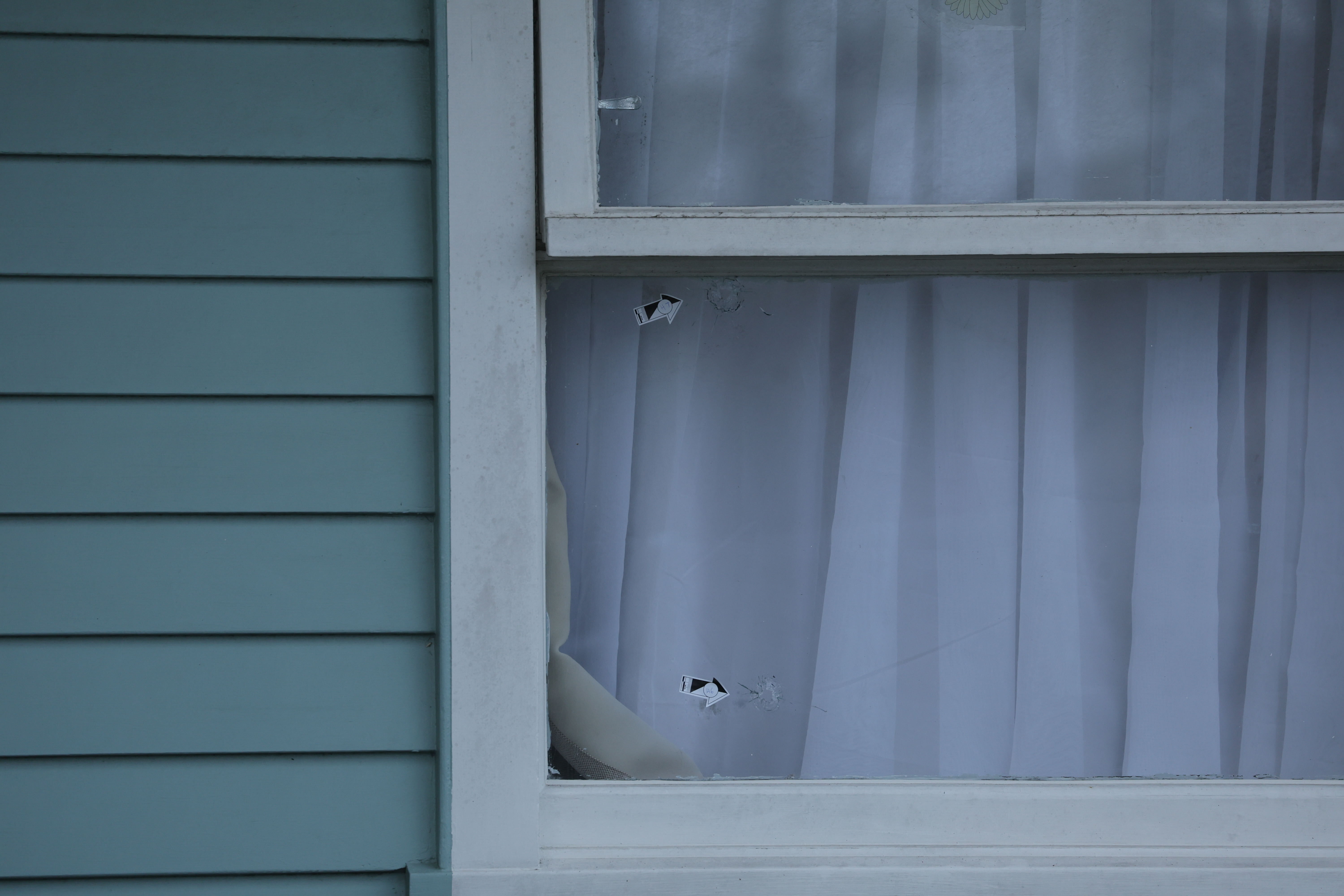 Stickers point to apparent bullet holes in the windows of a Māngere East house. Photo / Jason Oxenham