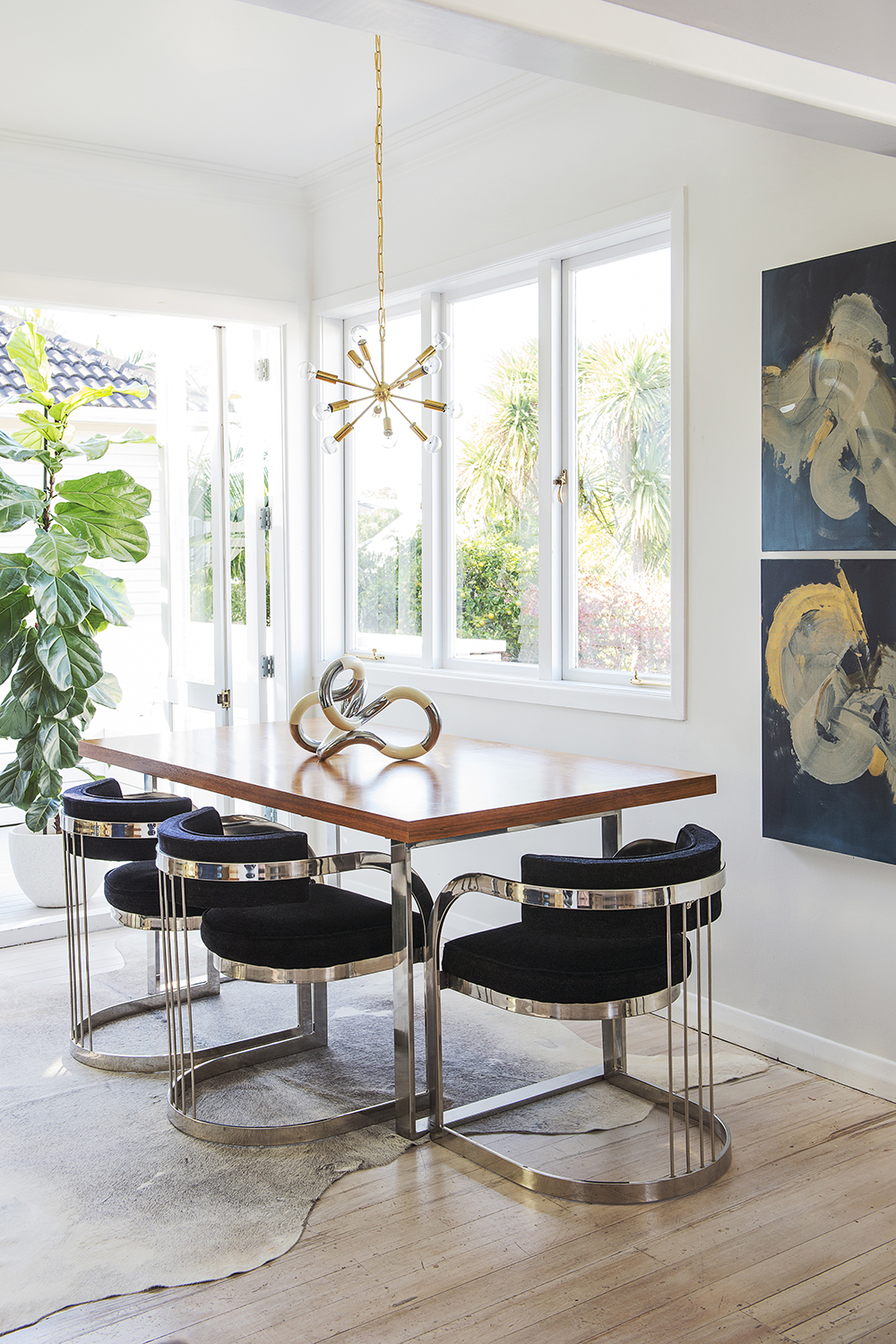 This dining area makes a statement with retro furniture and light fitting. Photo / Cave Bureau