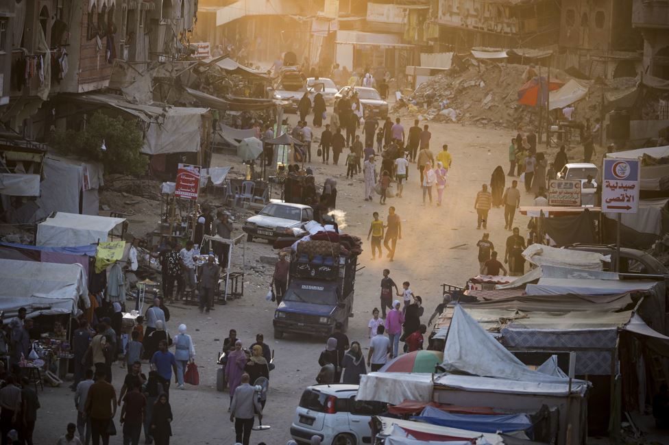Palestinians displaced by the Israeli bombardment of the Gaza Strip walk through a street market in Khan Younis, southern Gaza Strip. Photo / AP