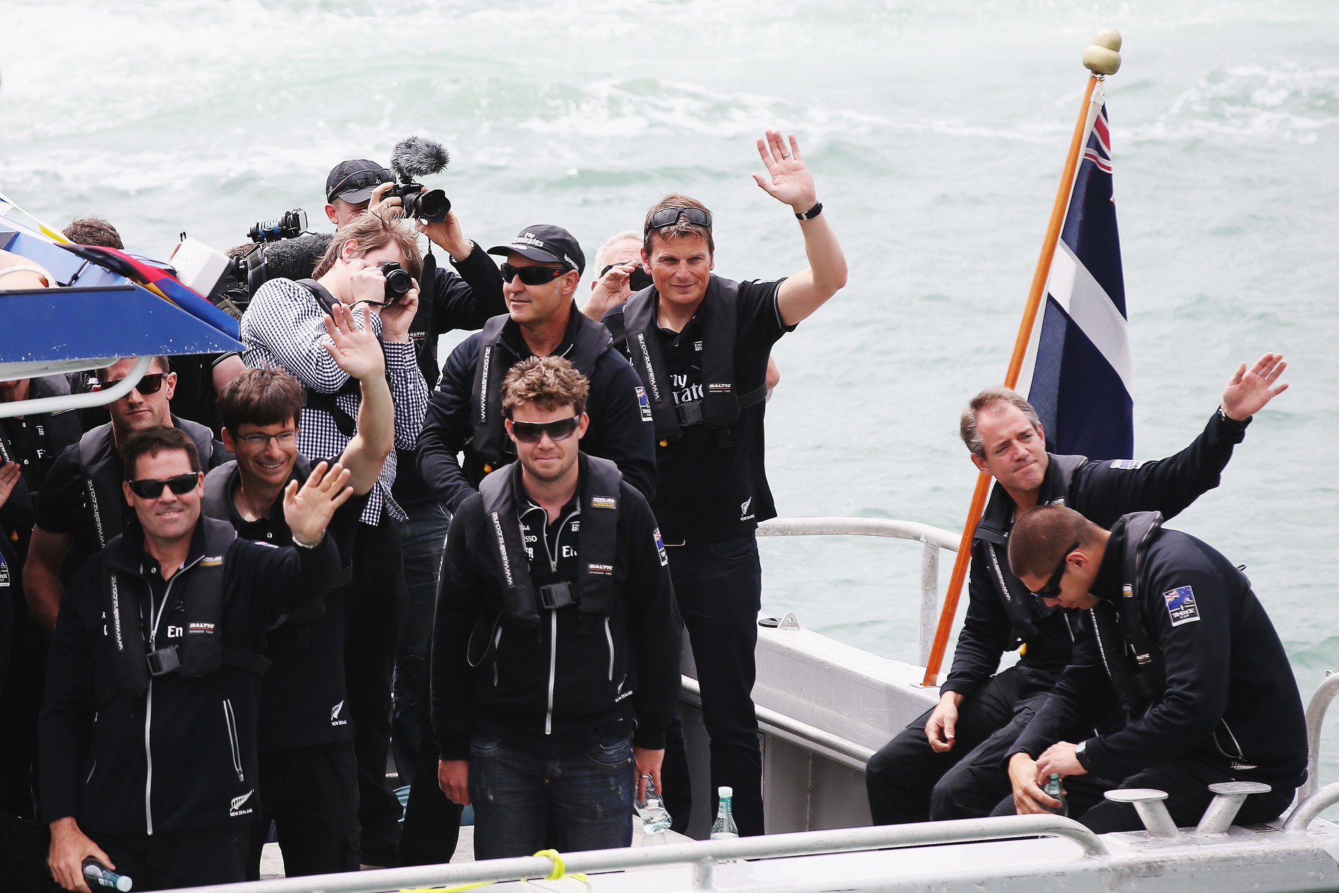 Members of Team New Zealand thank fans from the water during their official welcome home function at Shed 10 on October 4, 2013. Photo / Getty Images.